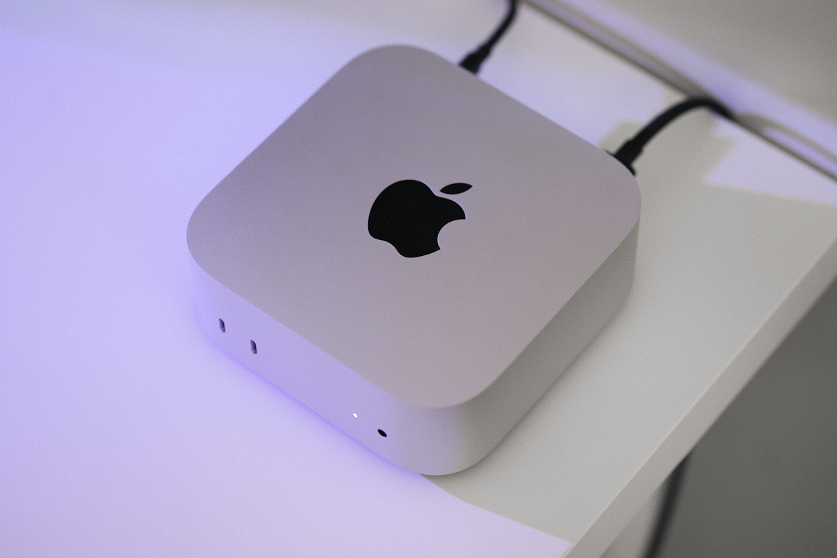 An apple computer sitting on top of a white table
