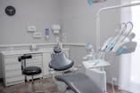 A dental room with a chair and a desk