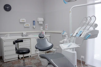 A dental room with a chair and a desk
