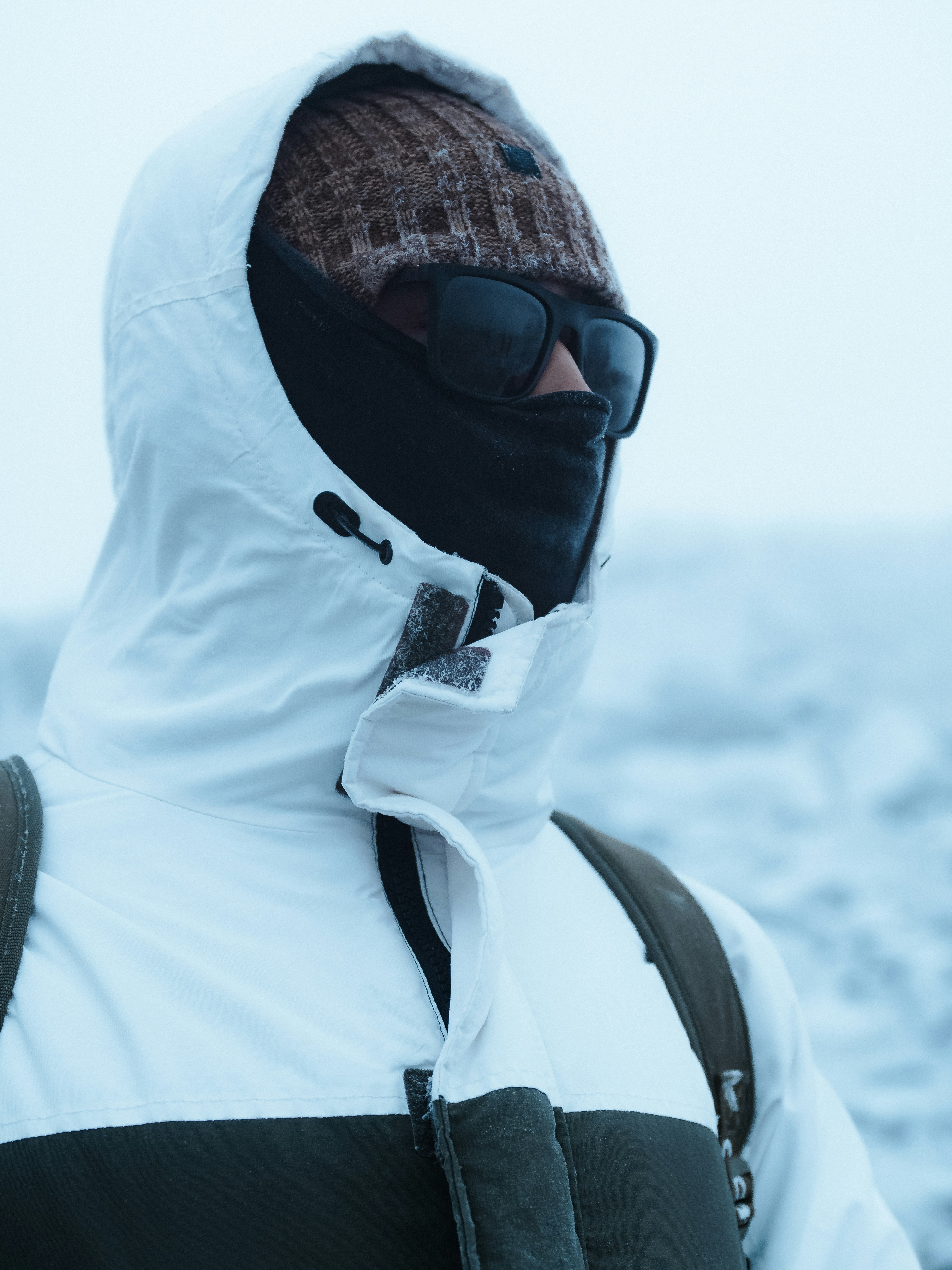 A man wearing a white jacket and a black hat