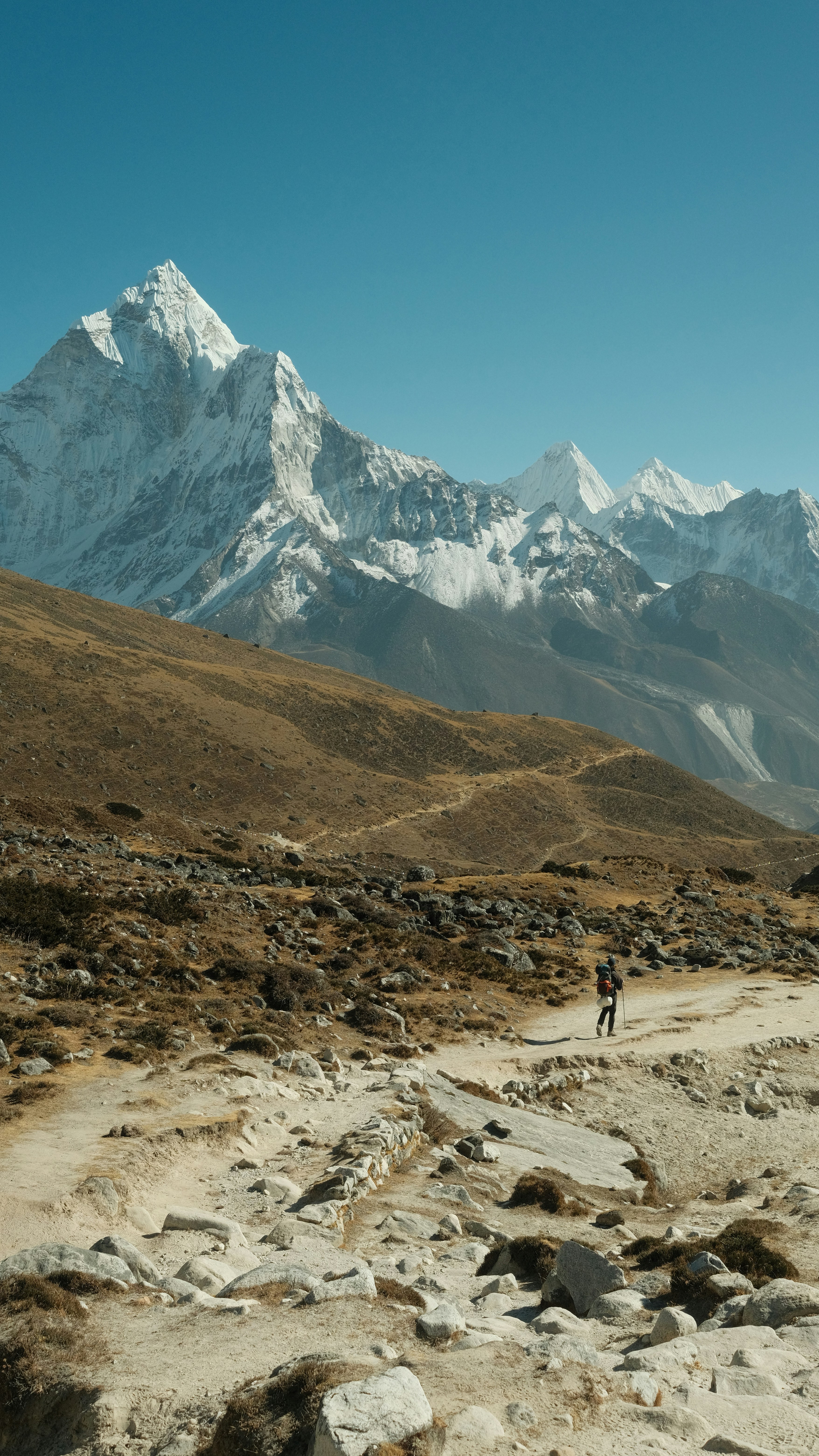 A man riding a bike down a dirt road