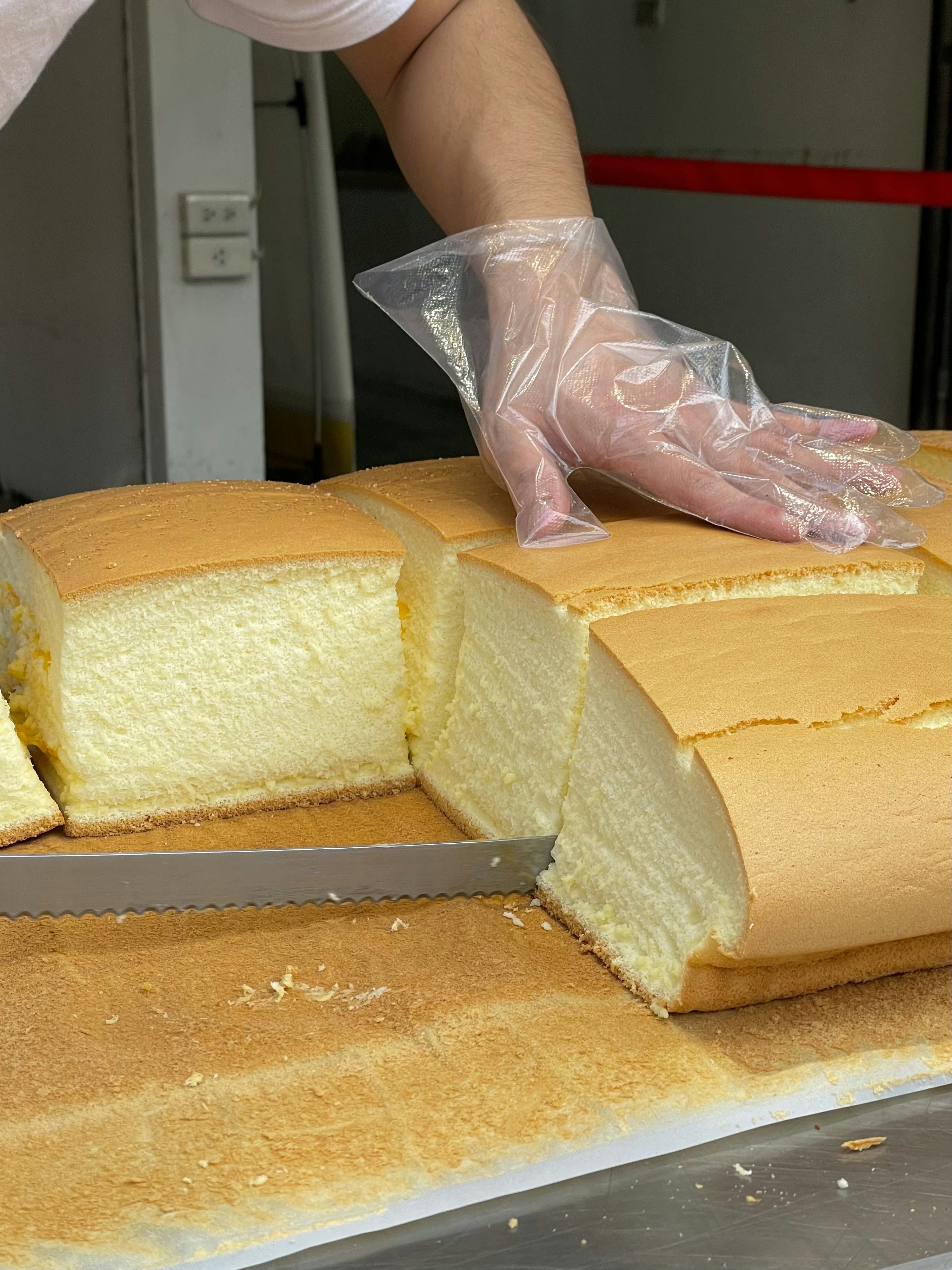 A person cutting a cake with a knife