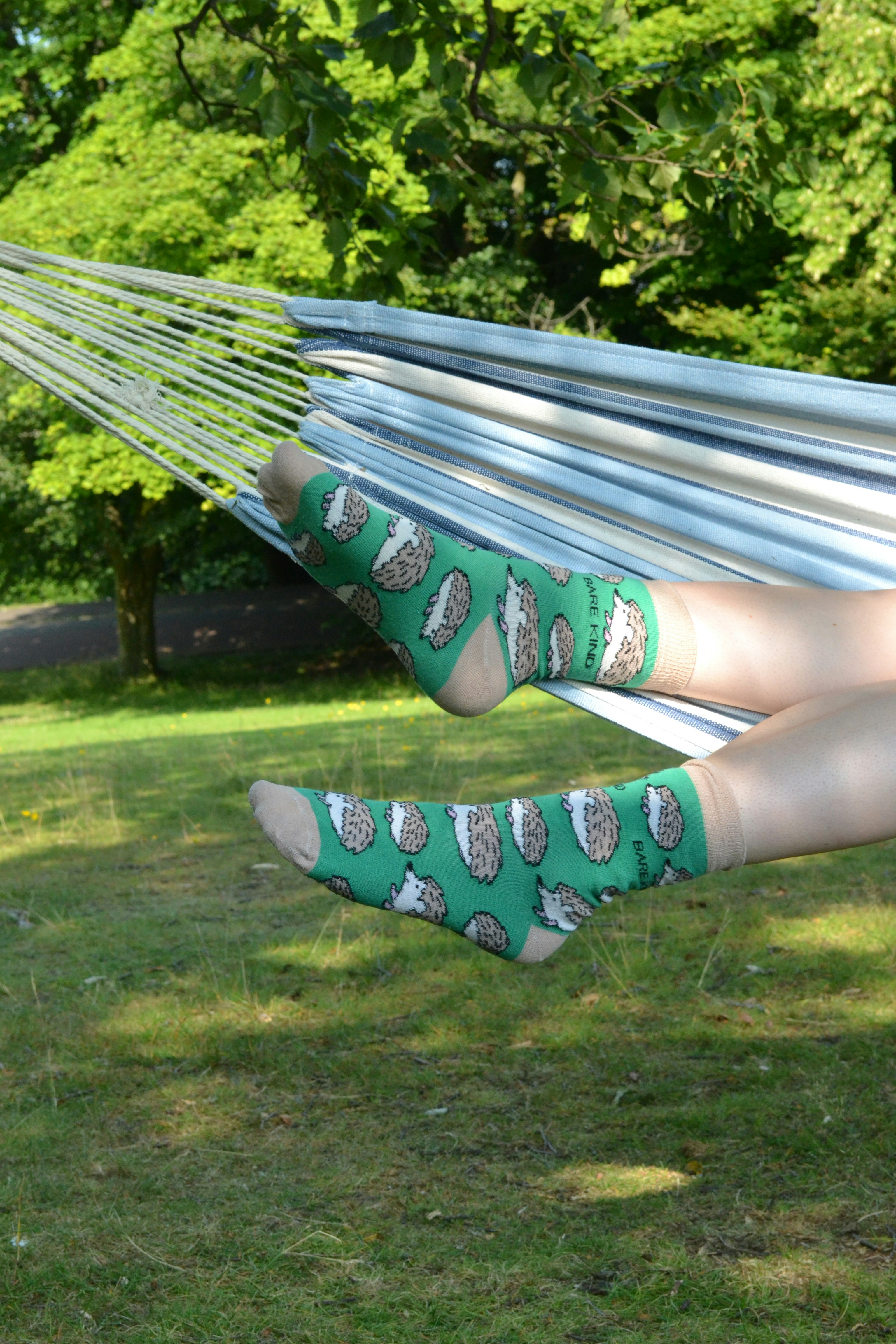 A woman laying in a hammock with her feet up