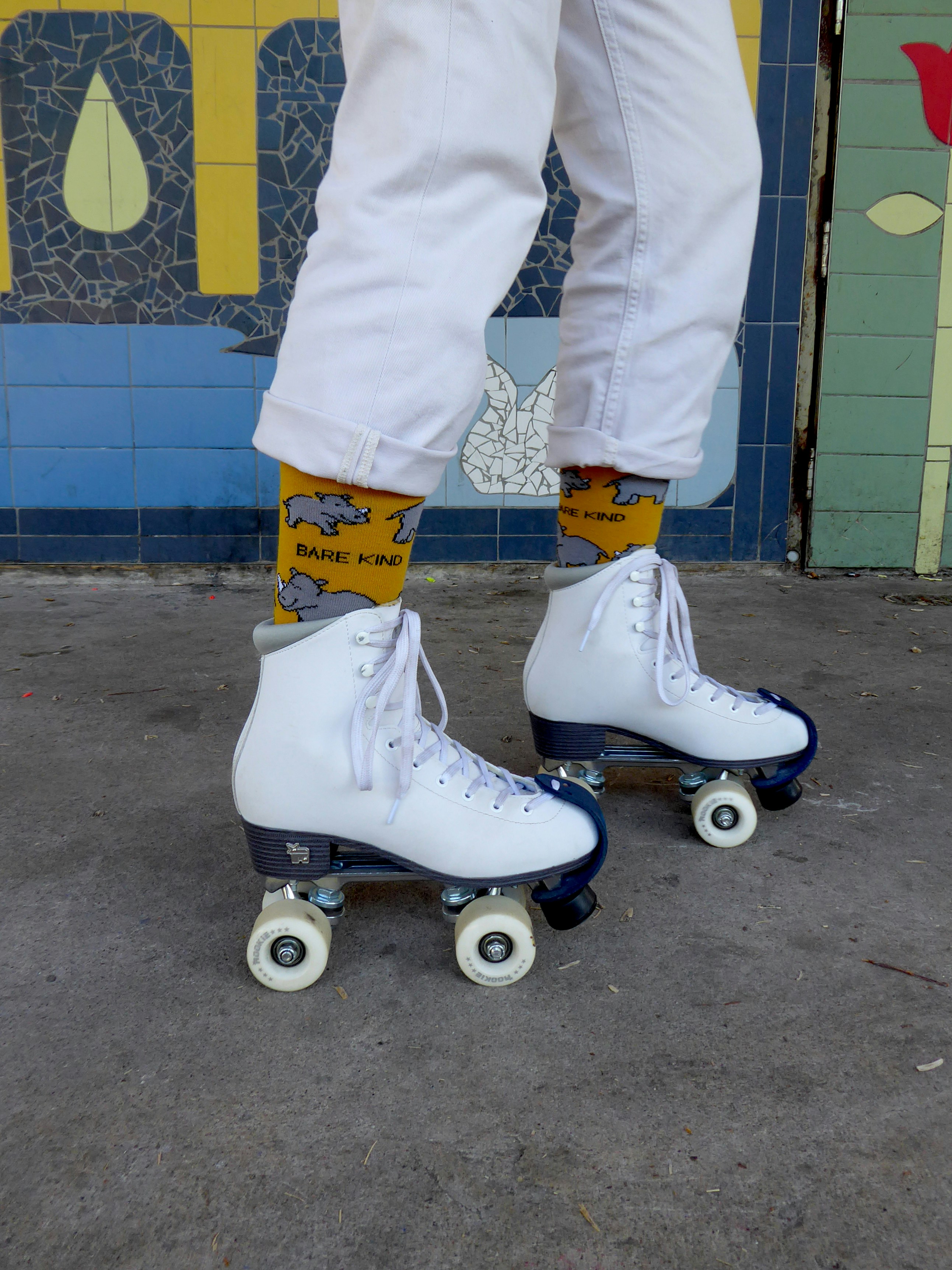 A person riding a skateboard on a sidewalk