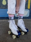 A person standing on roller skates in front of a wall