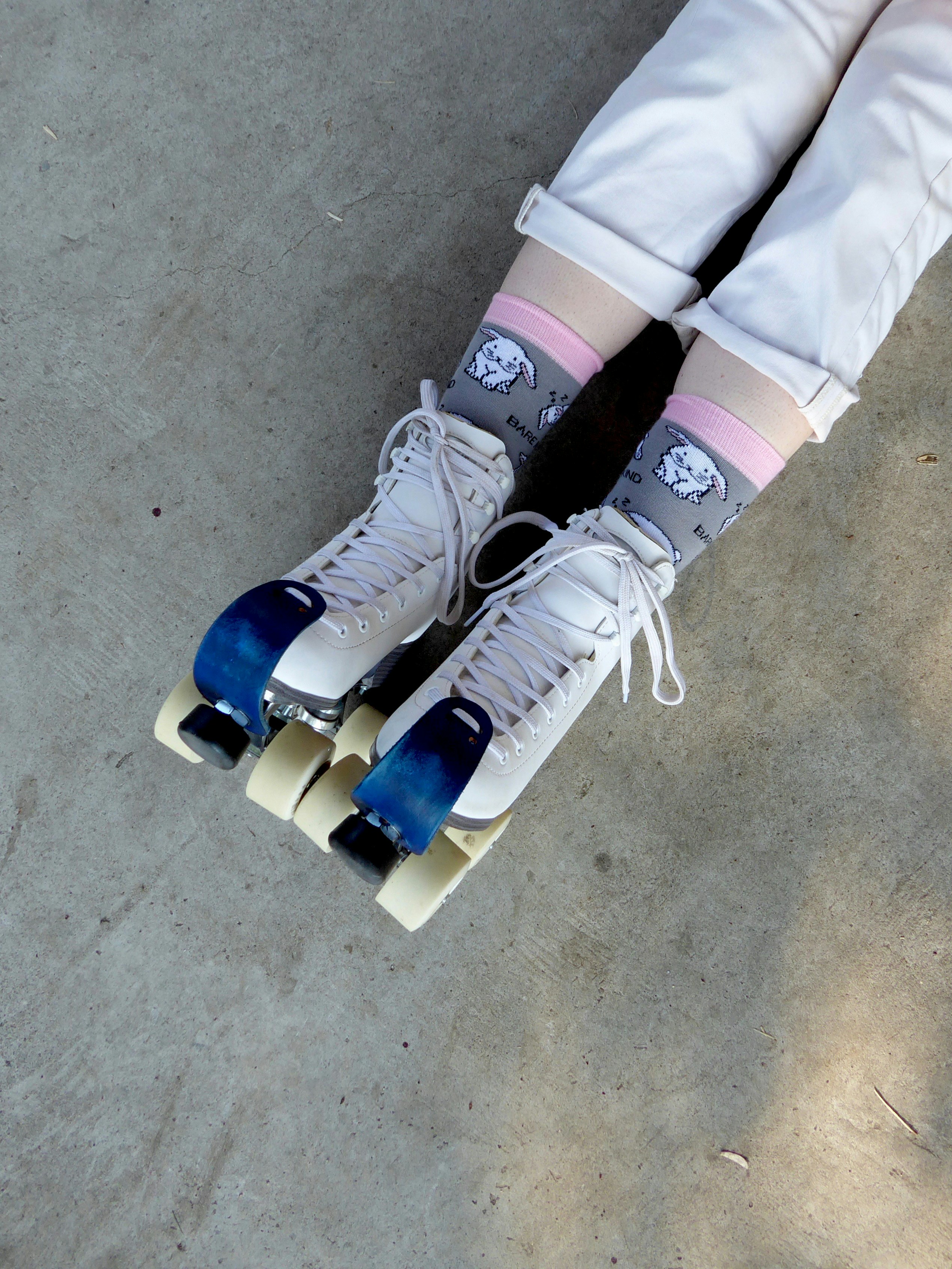 A person riding a skateboard down a sidewalk