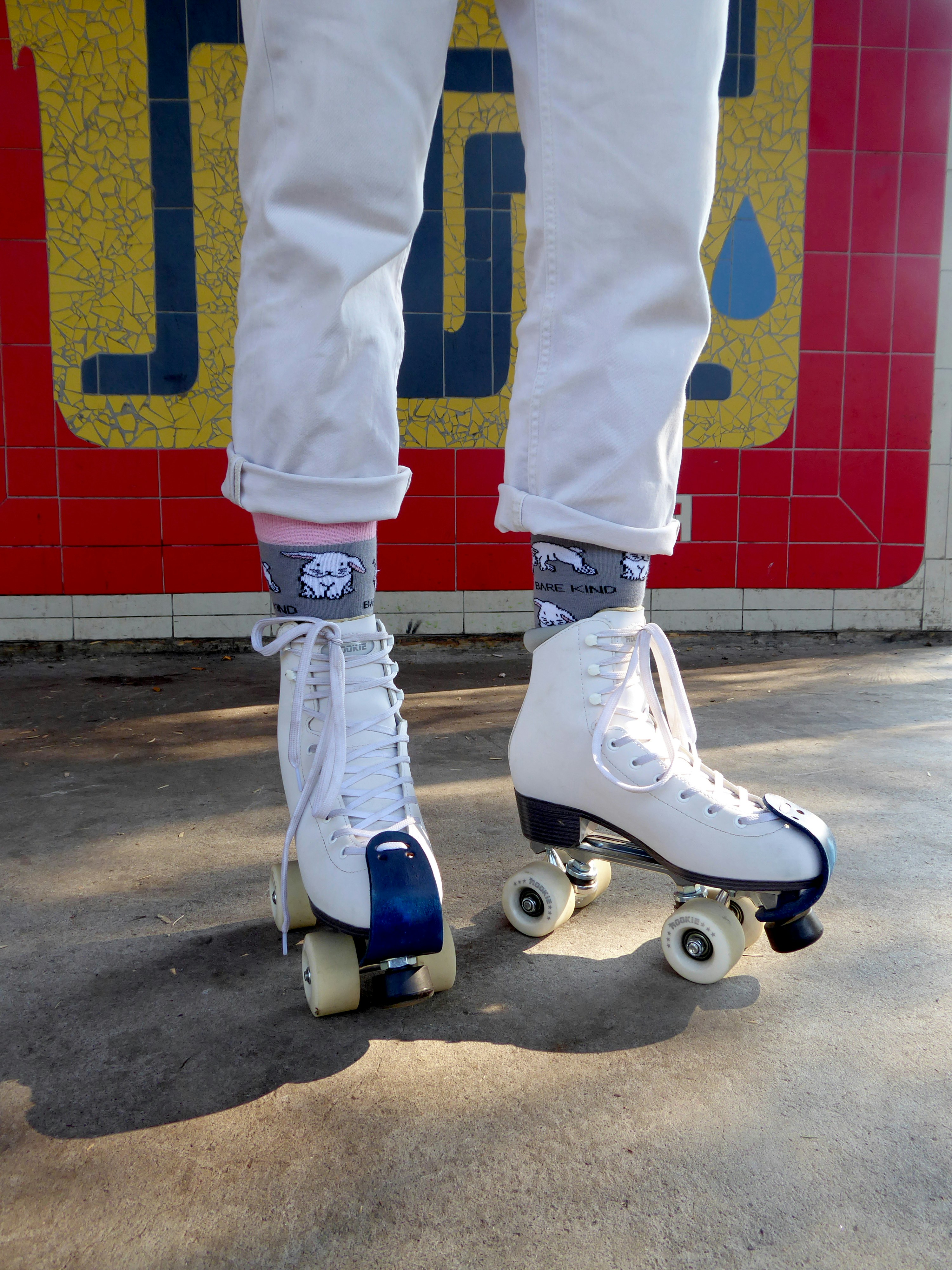 A person riding a skateboard on a sidewalk
