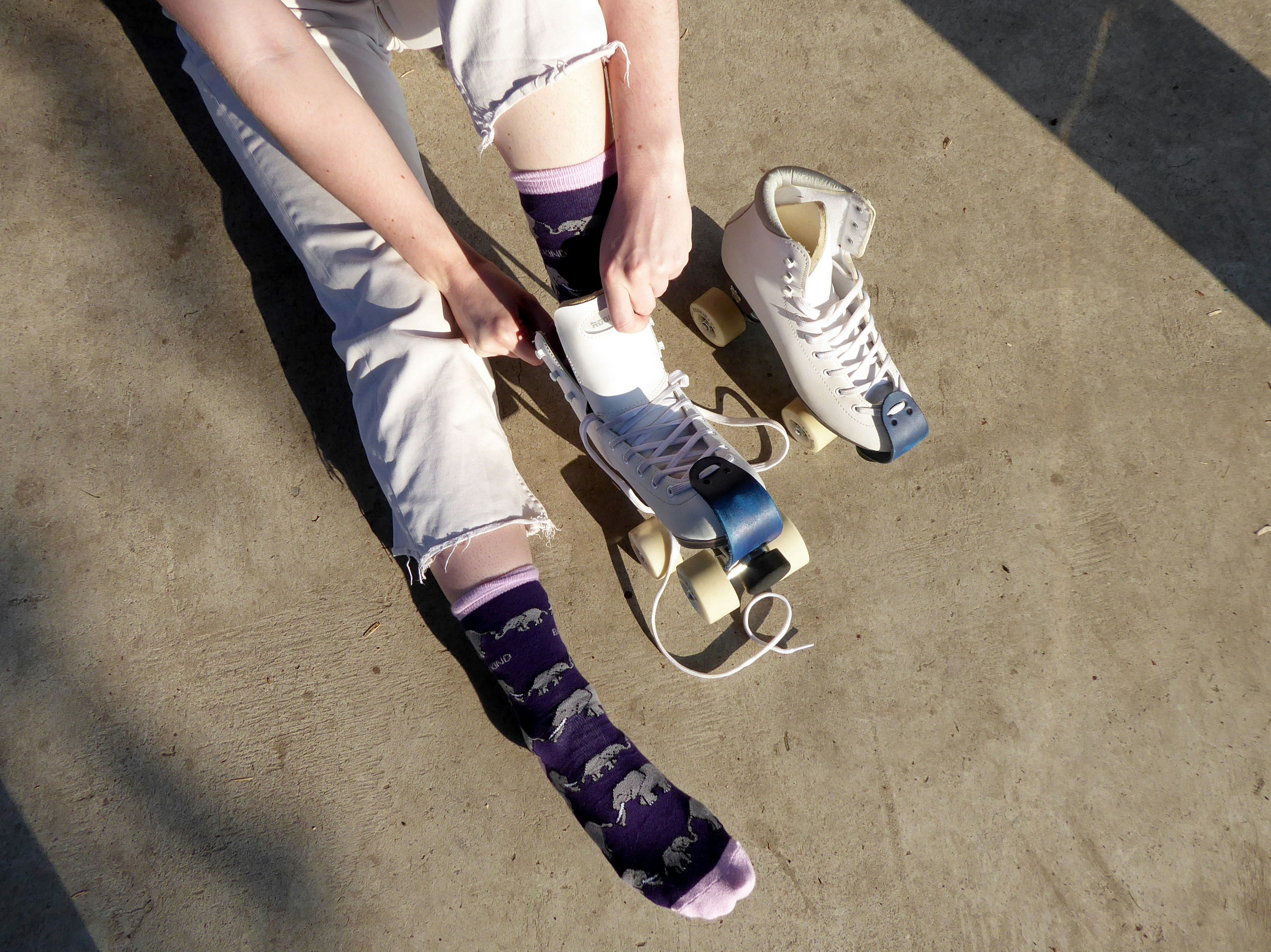 A person sitting on top of a skateboard