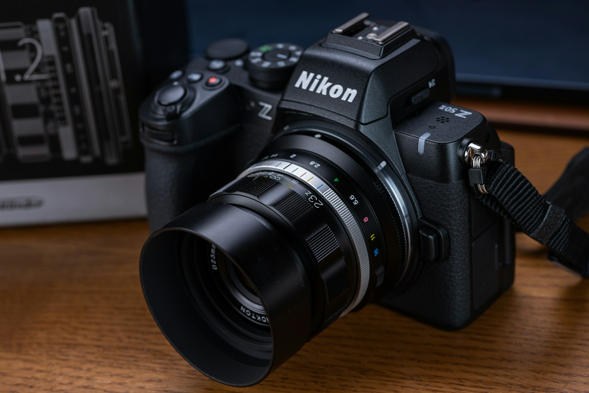 A black camera sitting on top of a wooden table