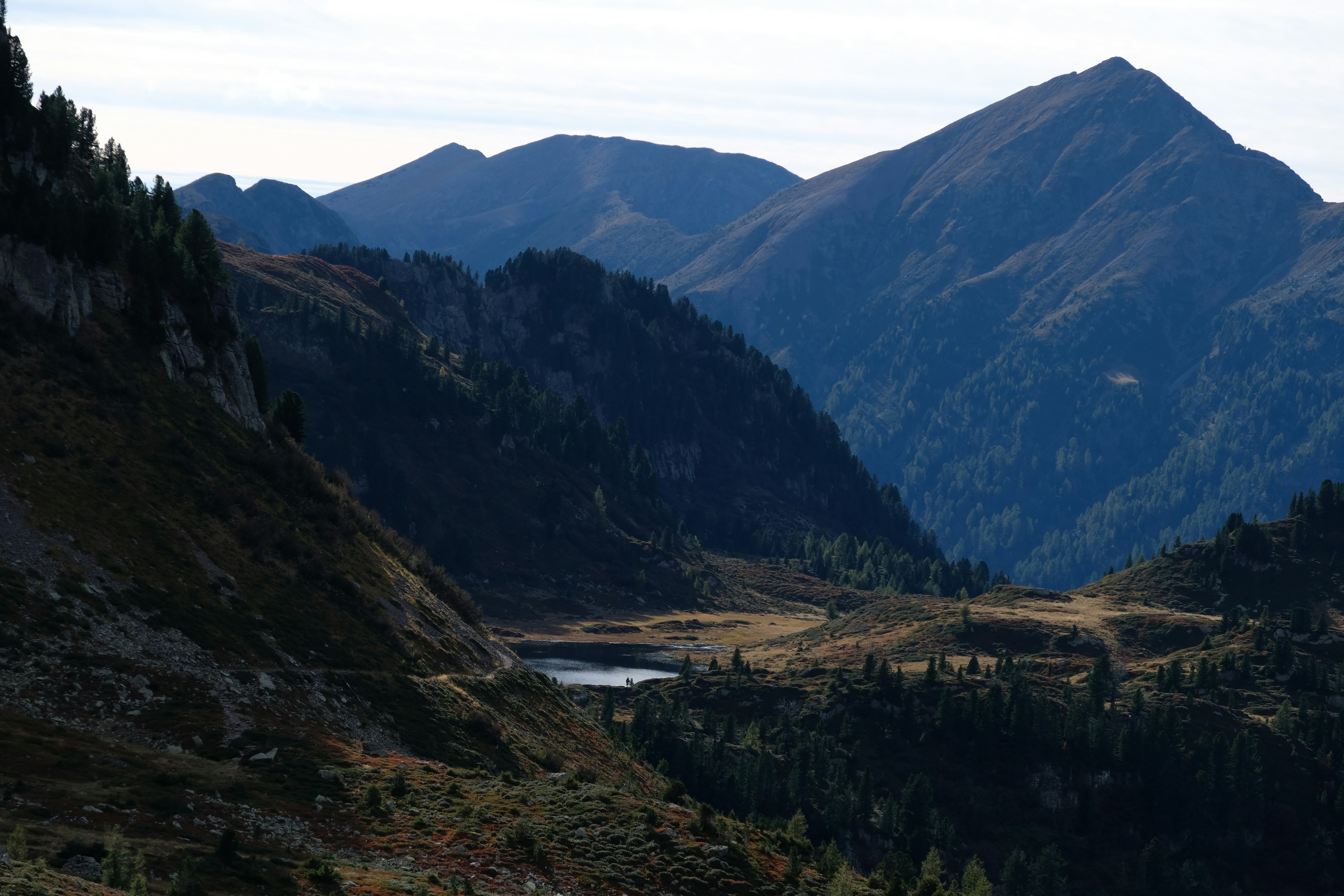 A view of a valley with mountains in the background