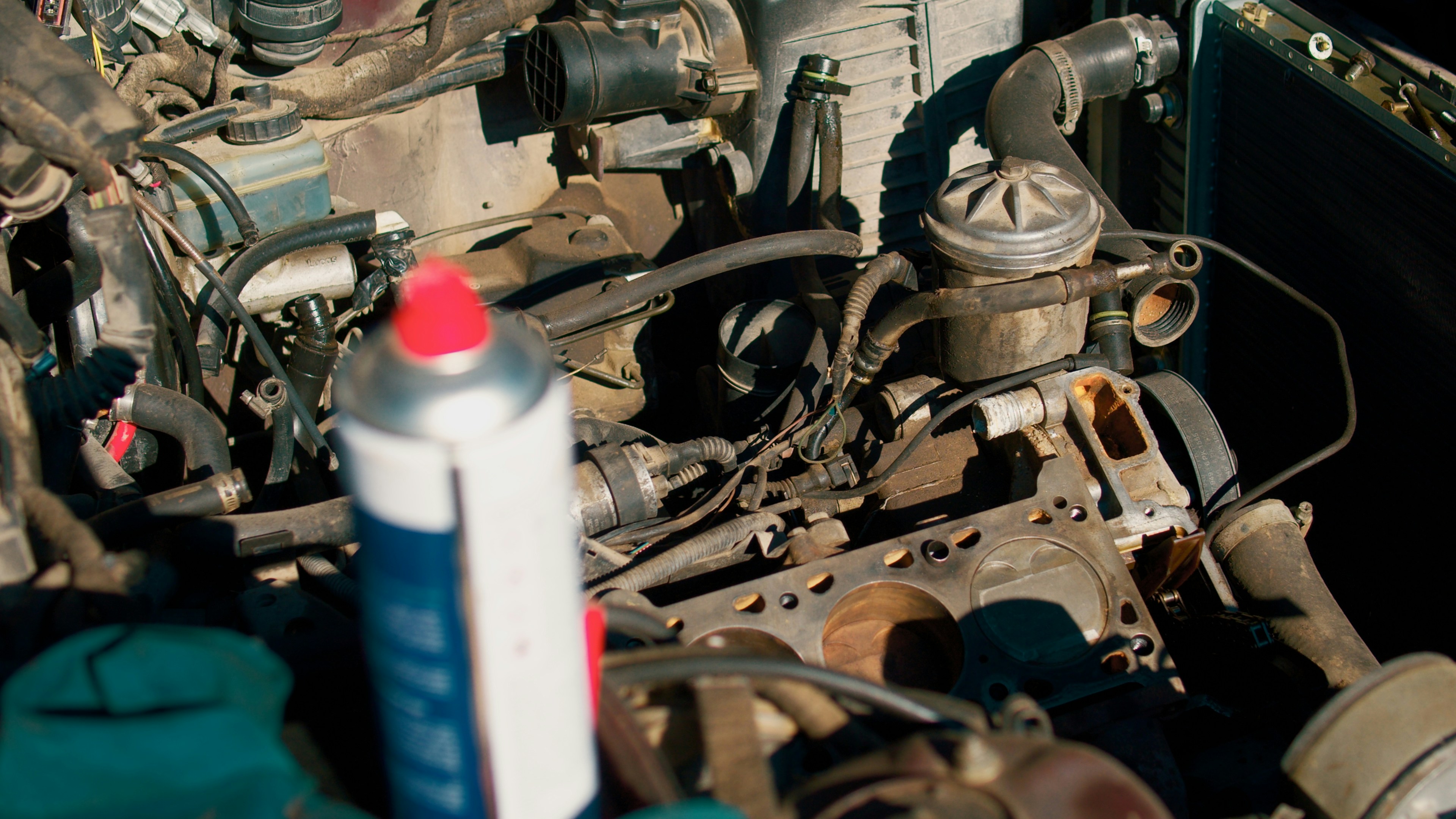 Technician checking engine oil level on an SUV using a dipstick