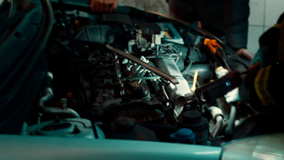 A man working on a car engine in a garage