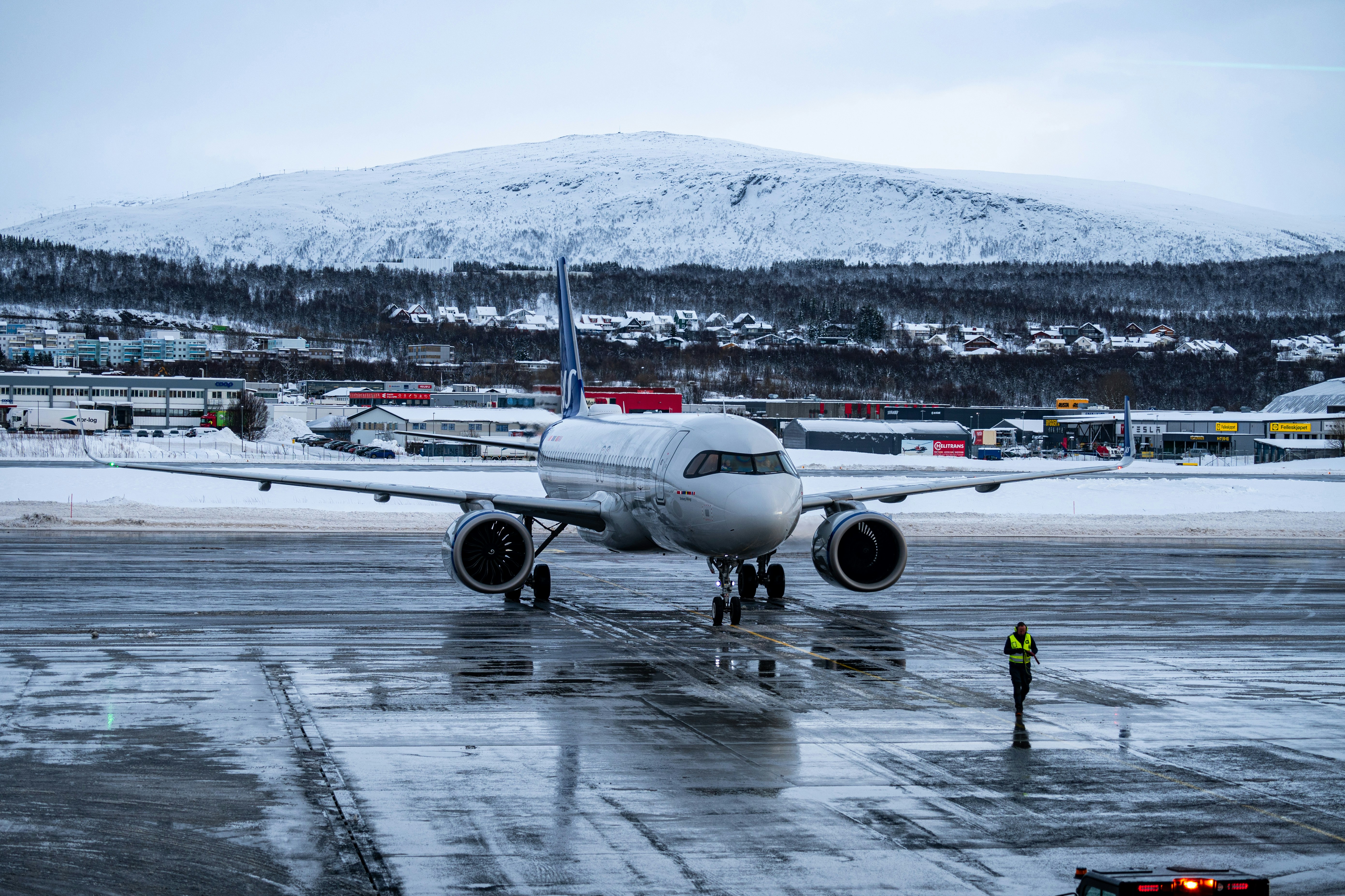 A large jetliner sitting on top of an airport tarmac, 