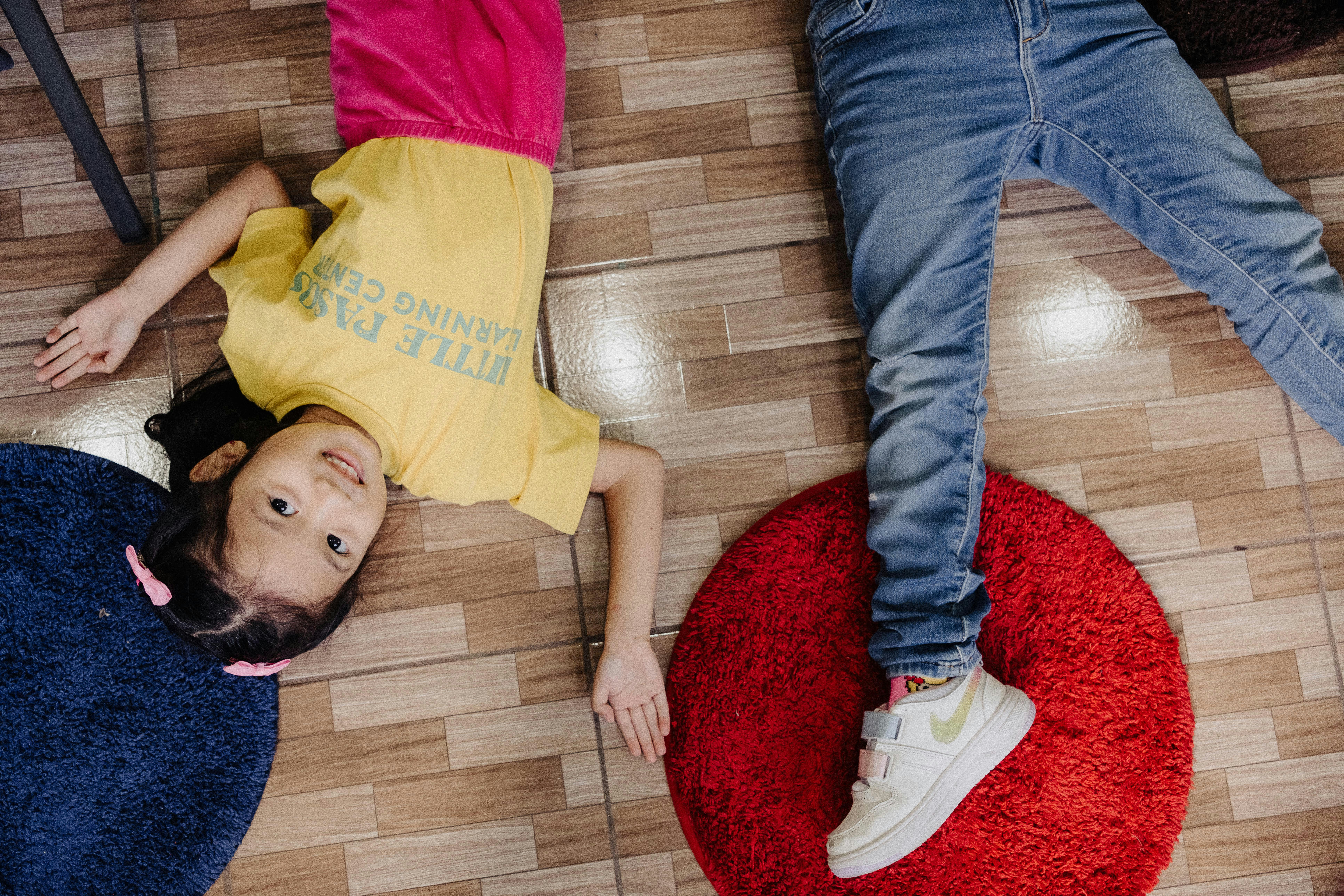 A group of people laying on top of a wooden floor