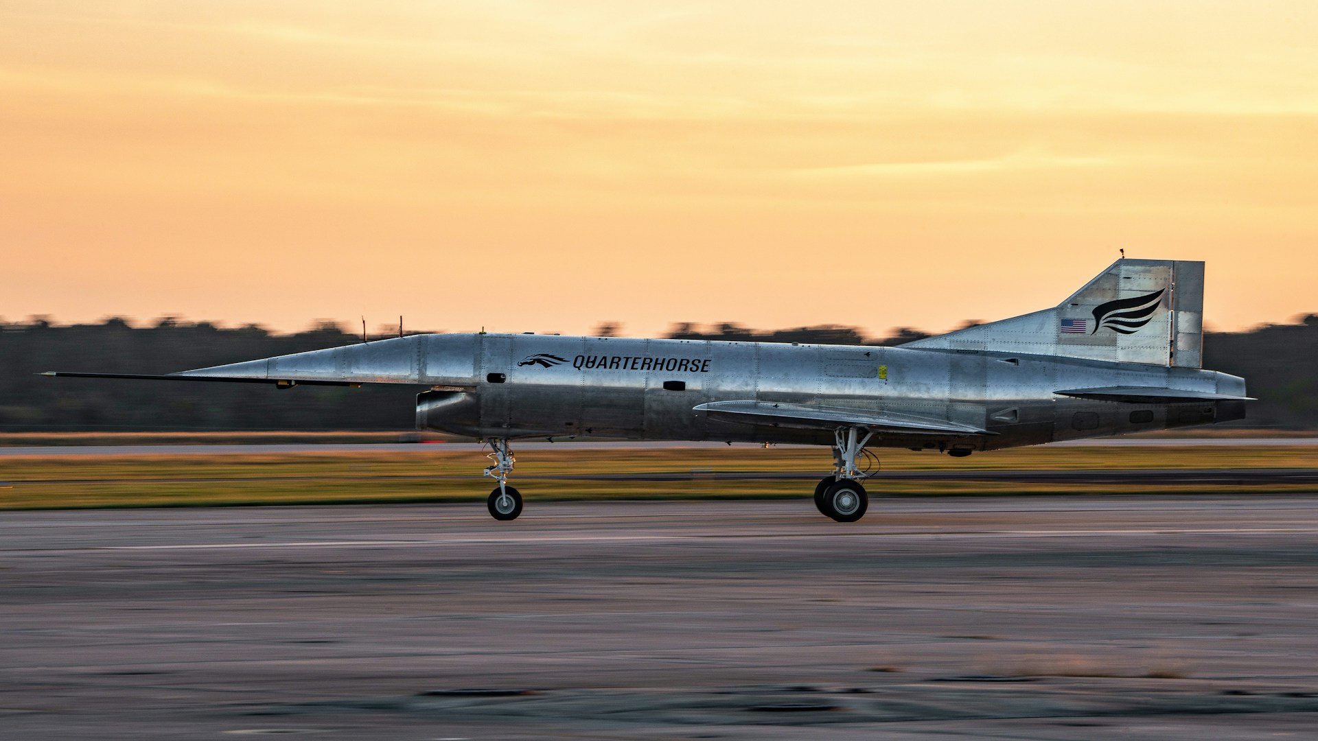 A fighter jet taking off from an airport runway