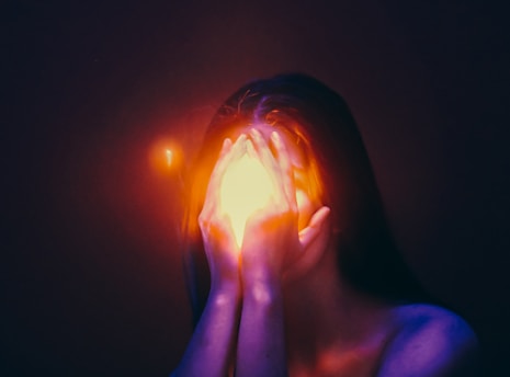 A woman covering her face with her hands