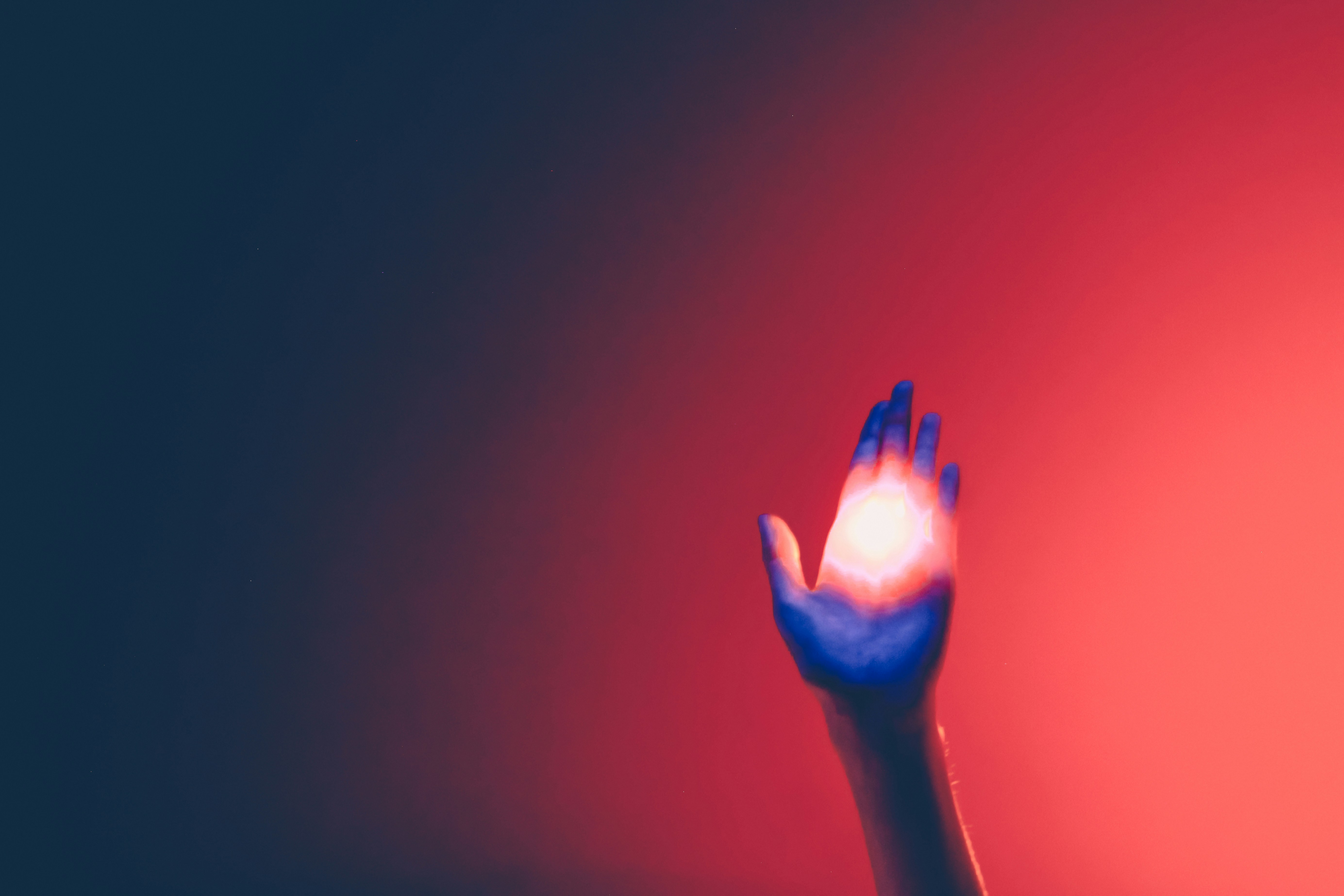 A person's hand calmly touches a glowing, abstract data visualization on a screen, illustrating the human interaction with new AI technology.