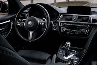 The interior of a car with a dashboard and steering wheel