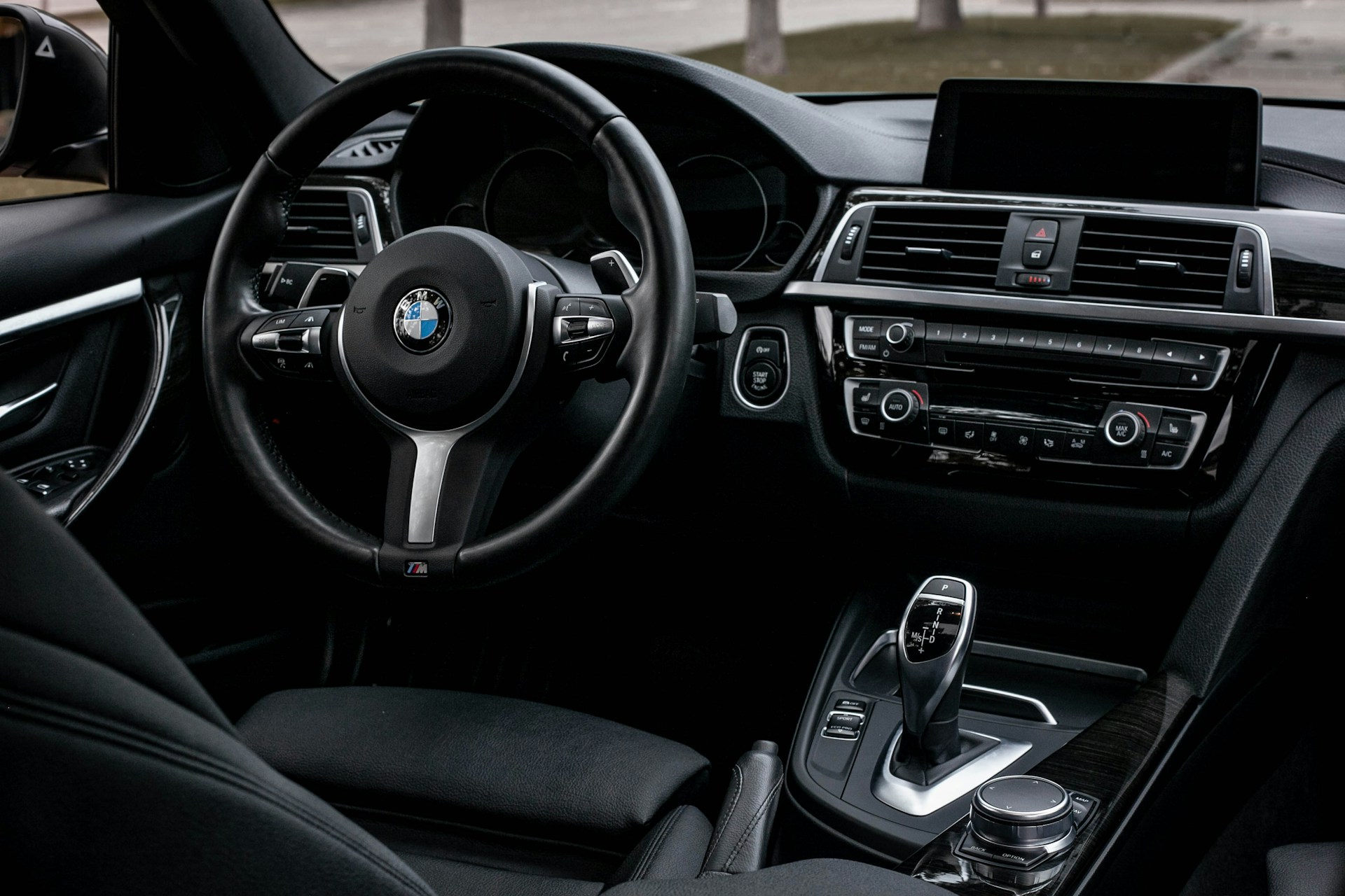 The interior of a car with a dashboard and steering wheel