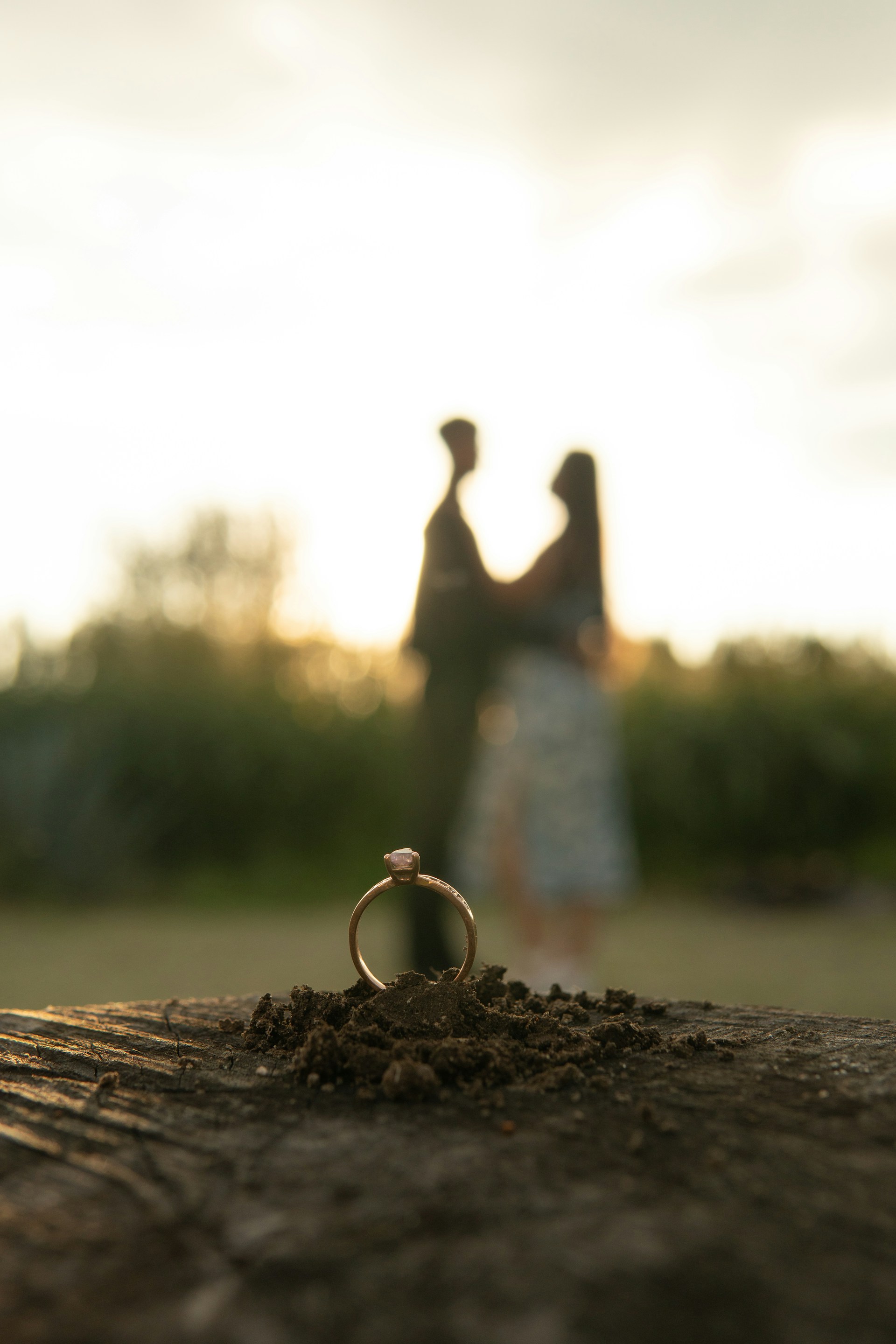 A couple standing next to each other near a ring