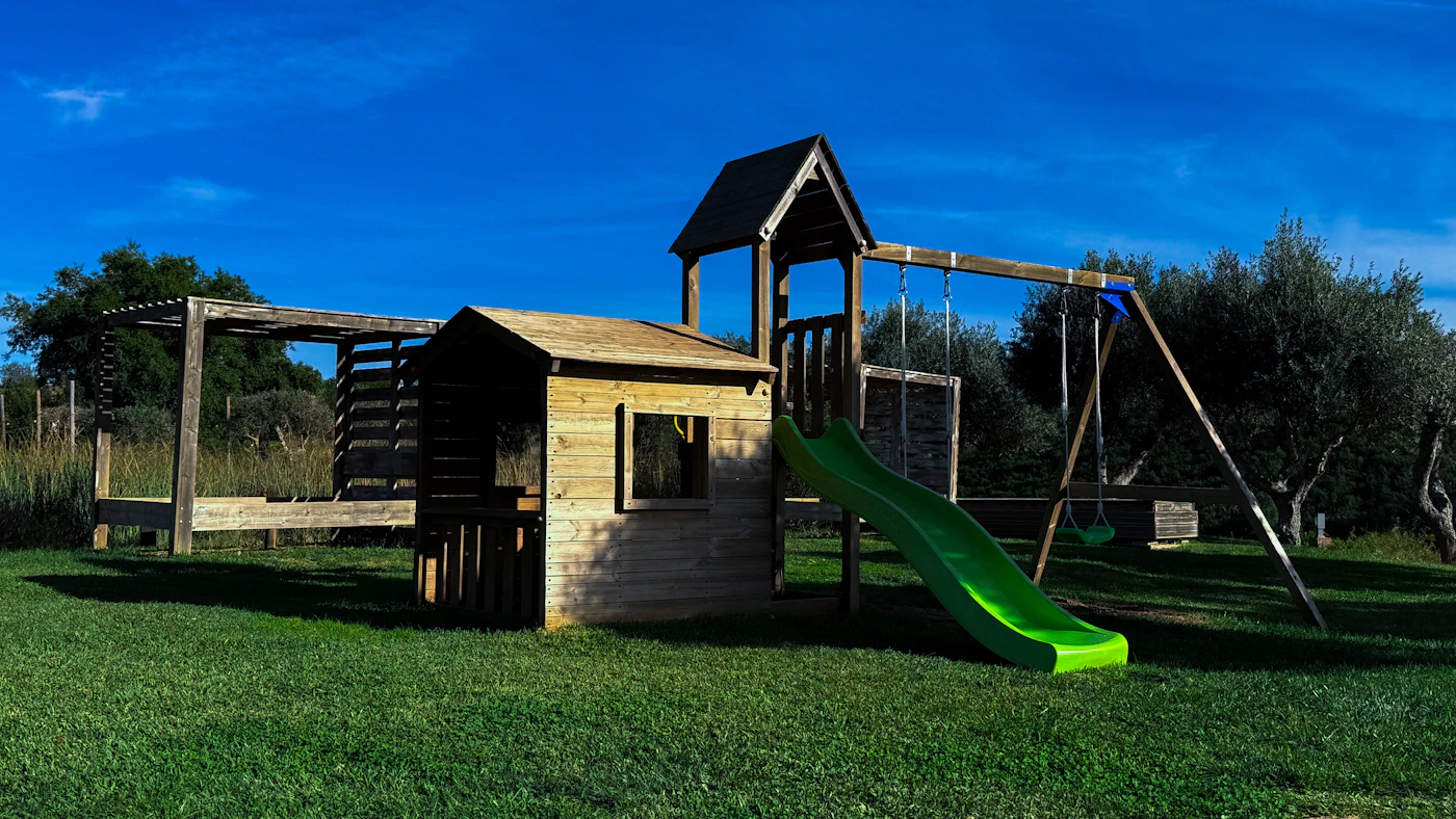 Wooden playset assembly in a San Diego backyard
