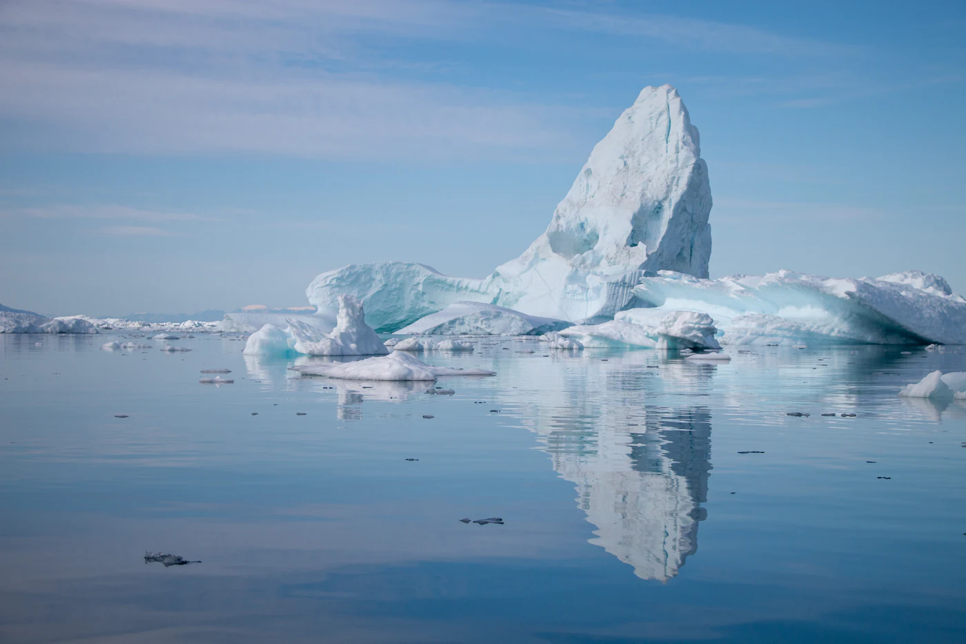 Iceberg reflected in calm water at Ilulissat, west Greenland