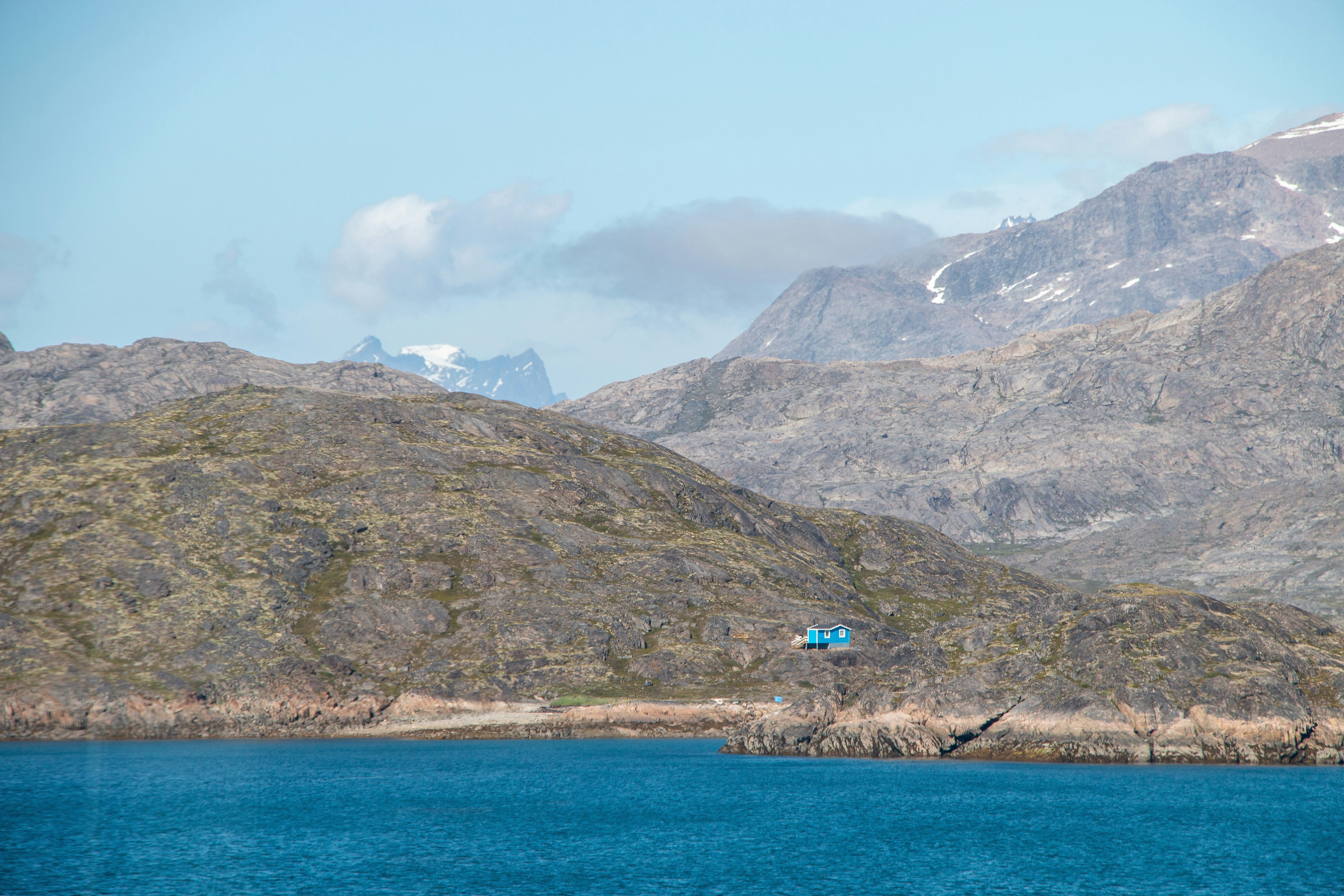 A body of water with mountains in the background