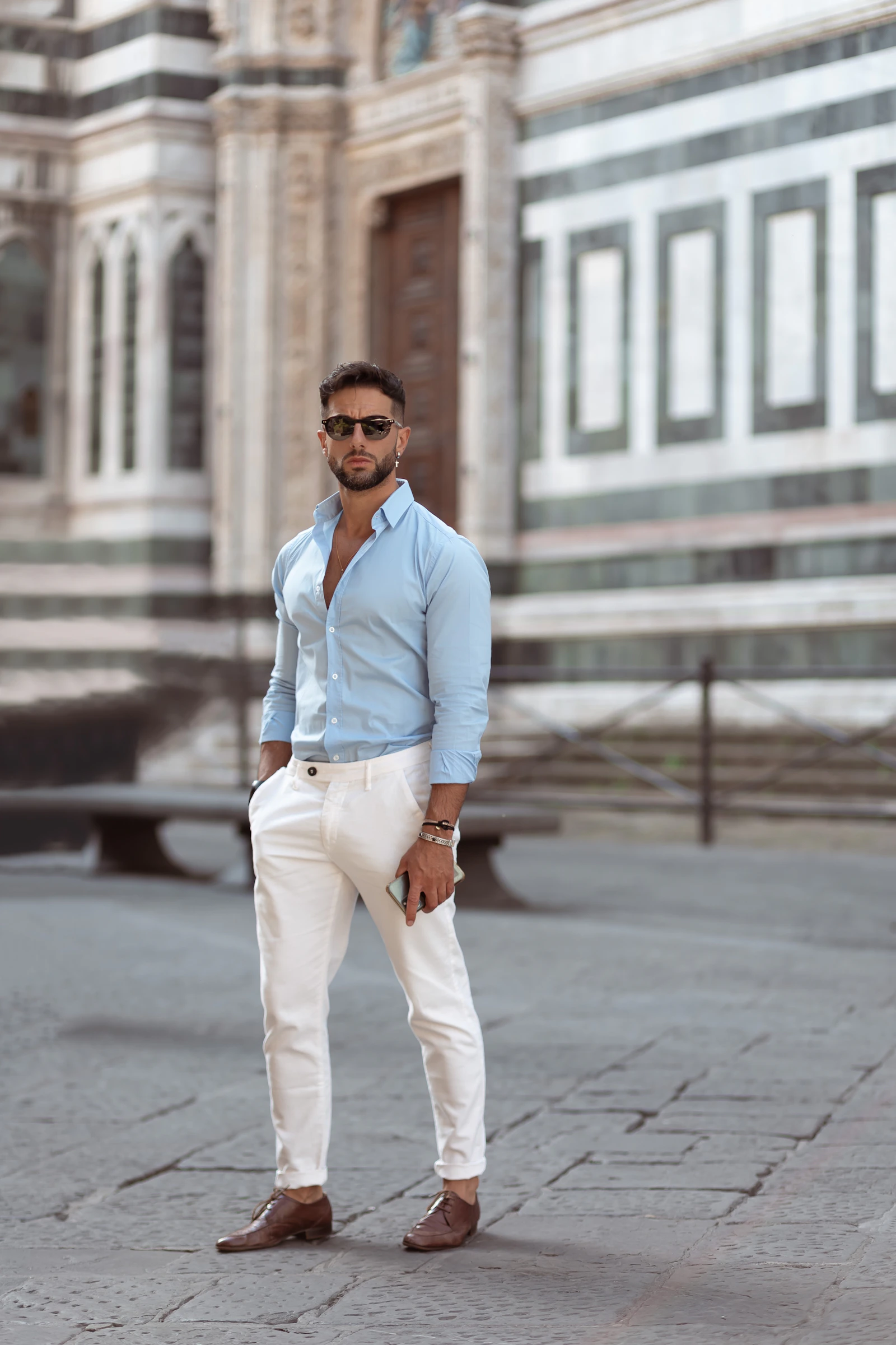 Man in blue shirt and white trousers