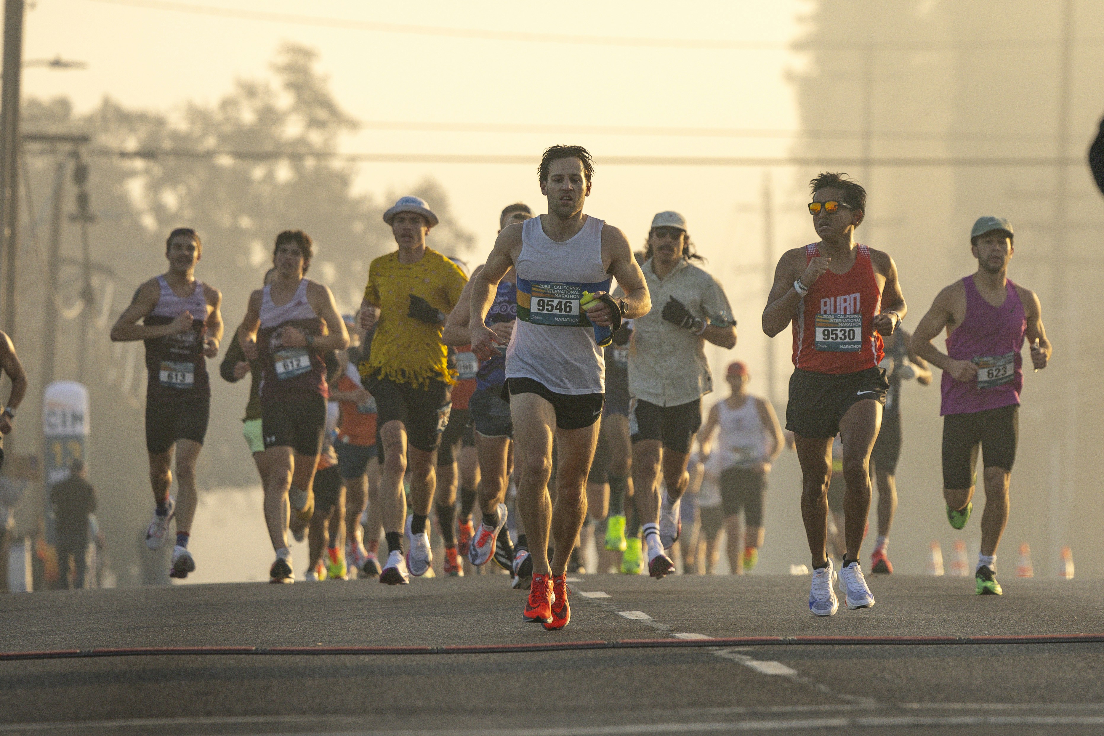 A group of people running down a street