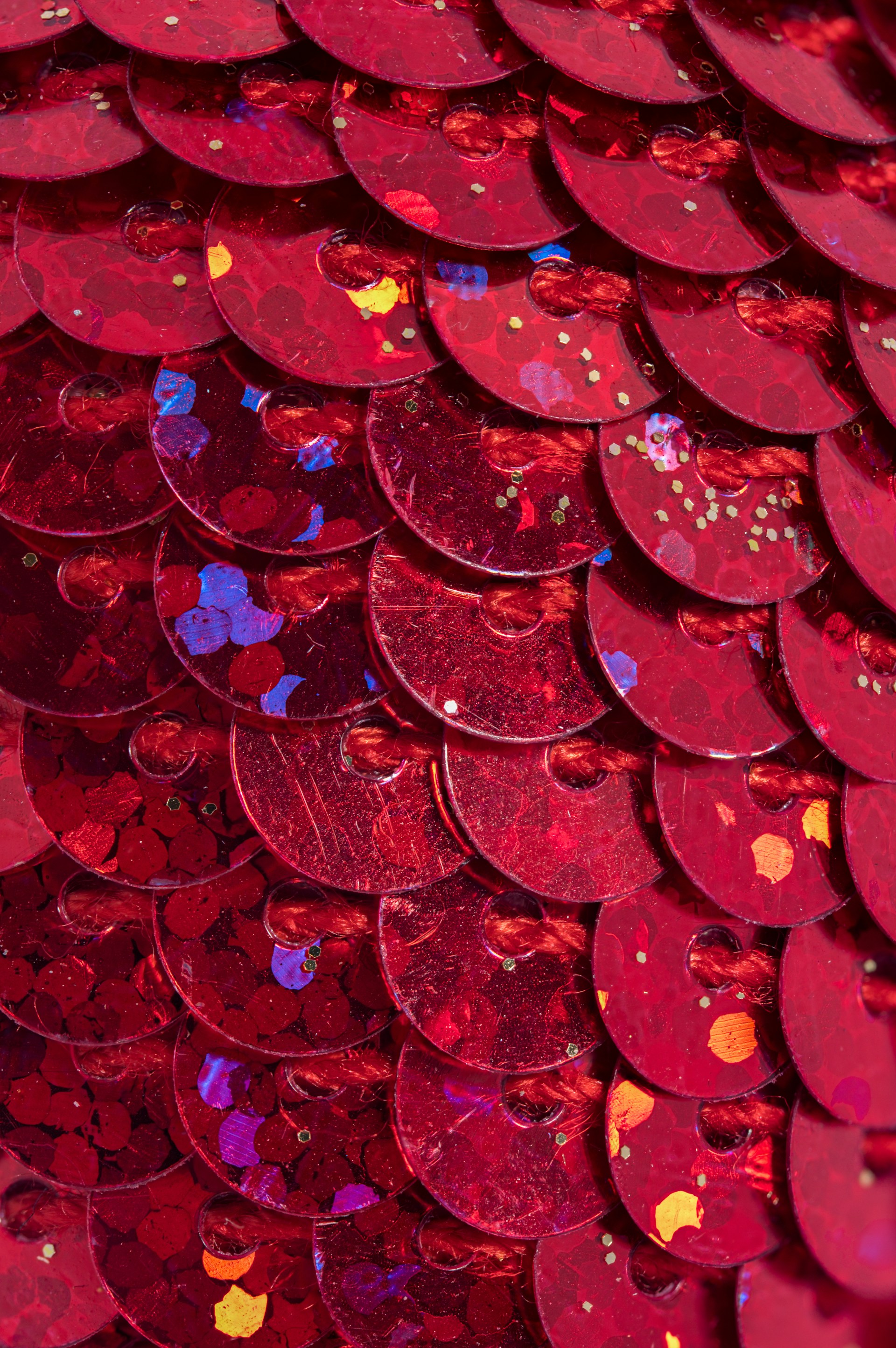 A close up of a red sequinized surface
