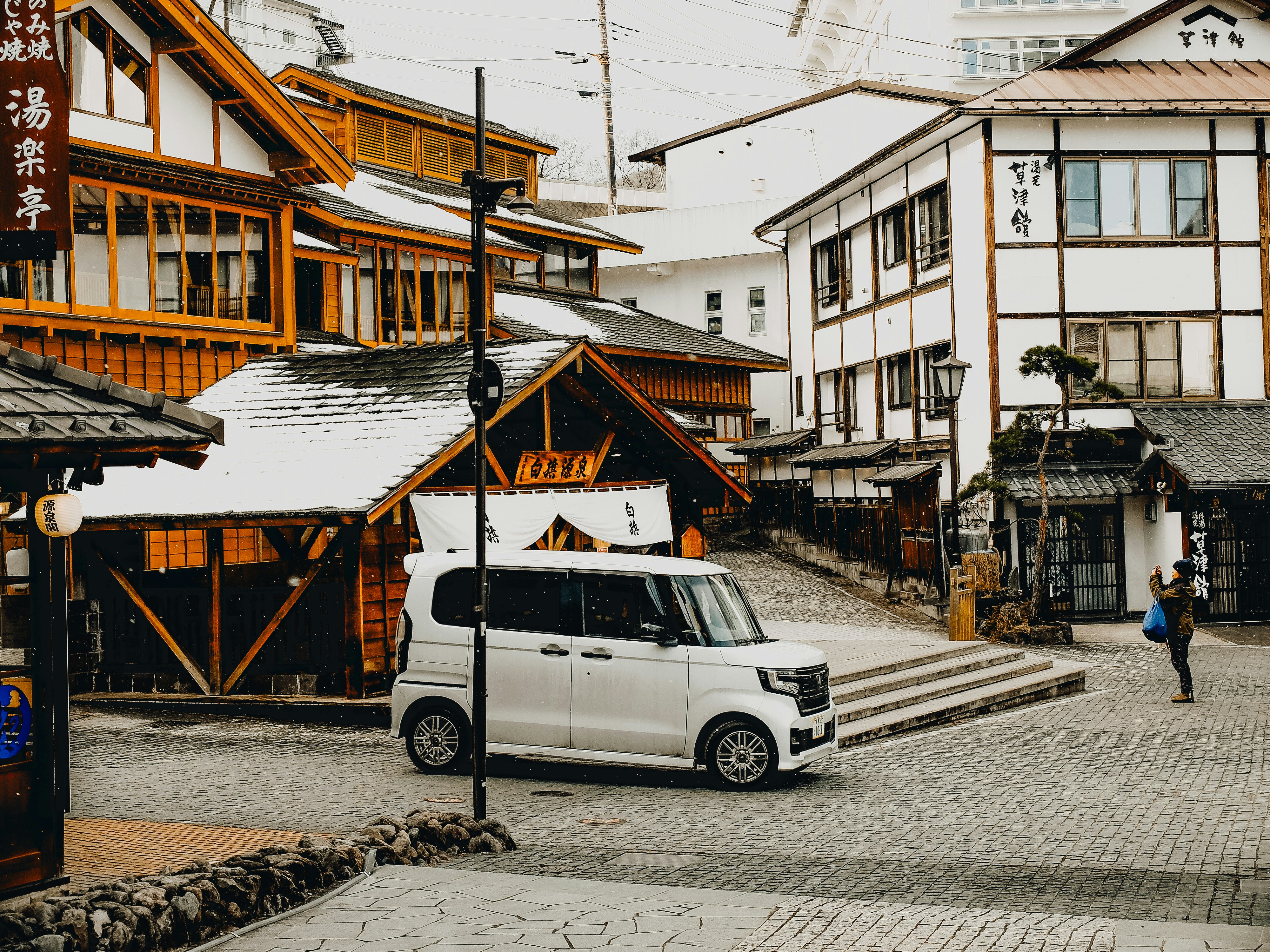 A van is parked in front of a building