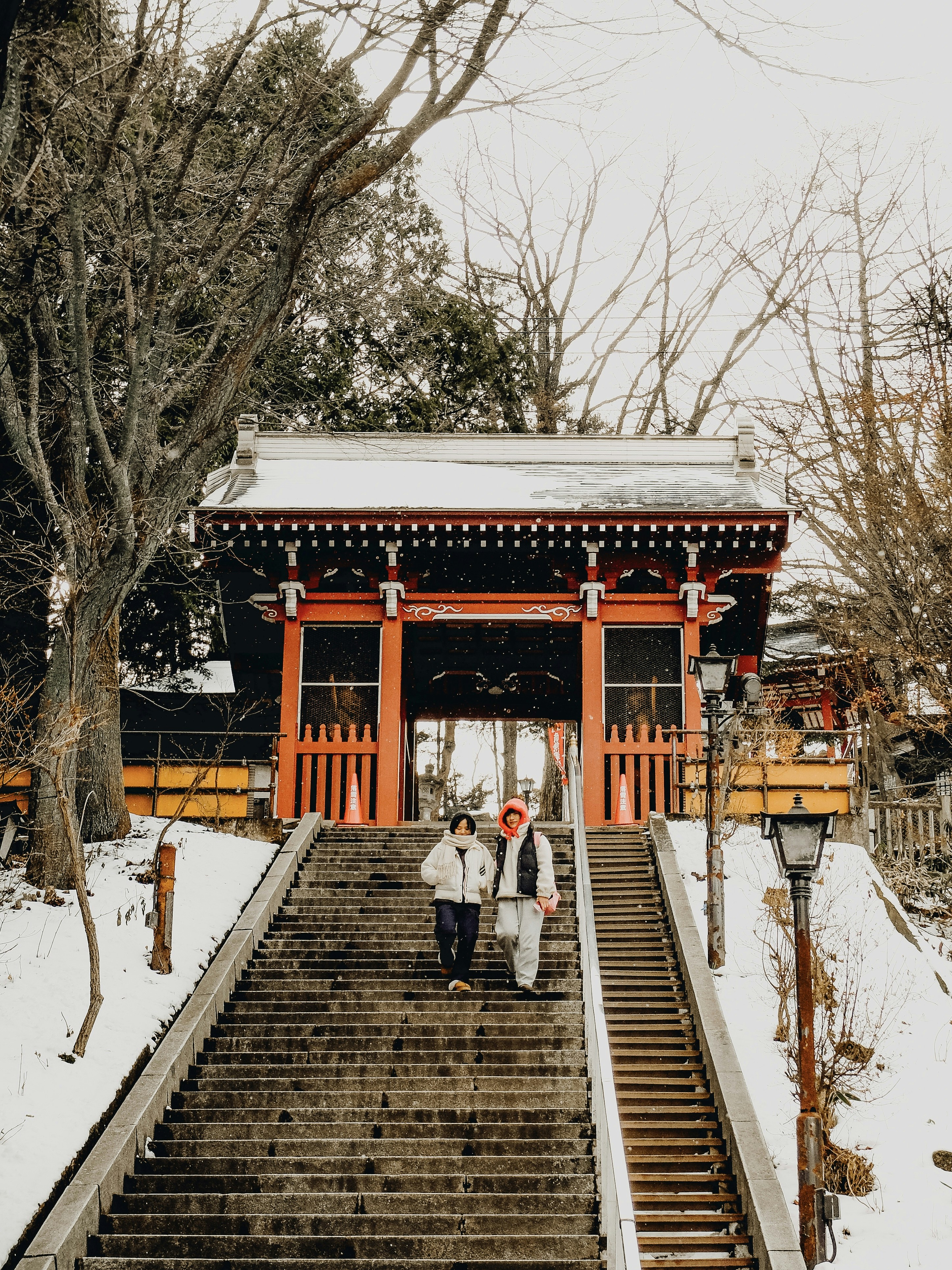 A couple of people walking up a set of stairs