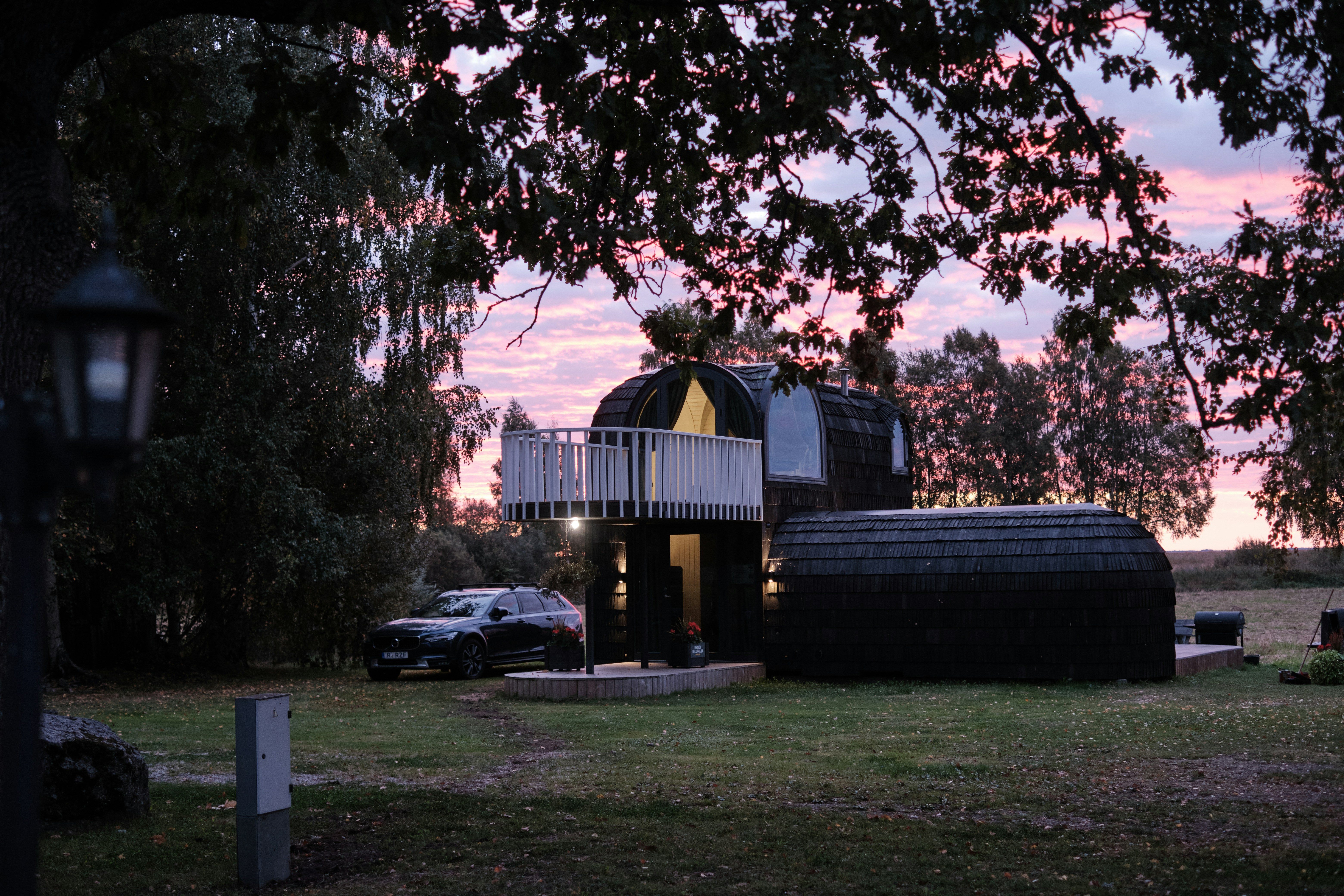 A house sitting on top of a lush green field