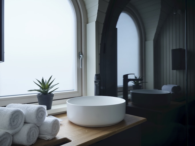 A bathroom with a large window and a bowl sink