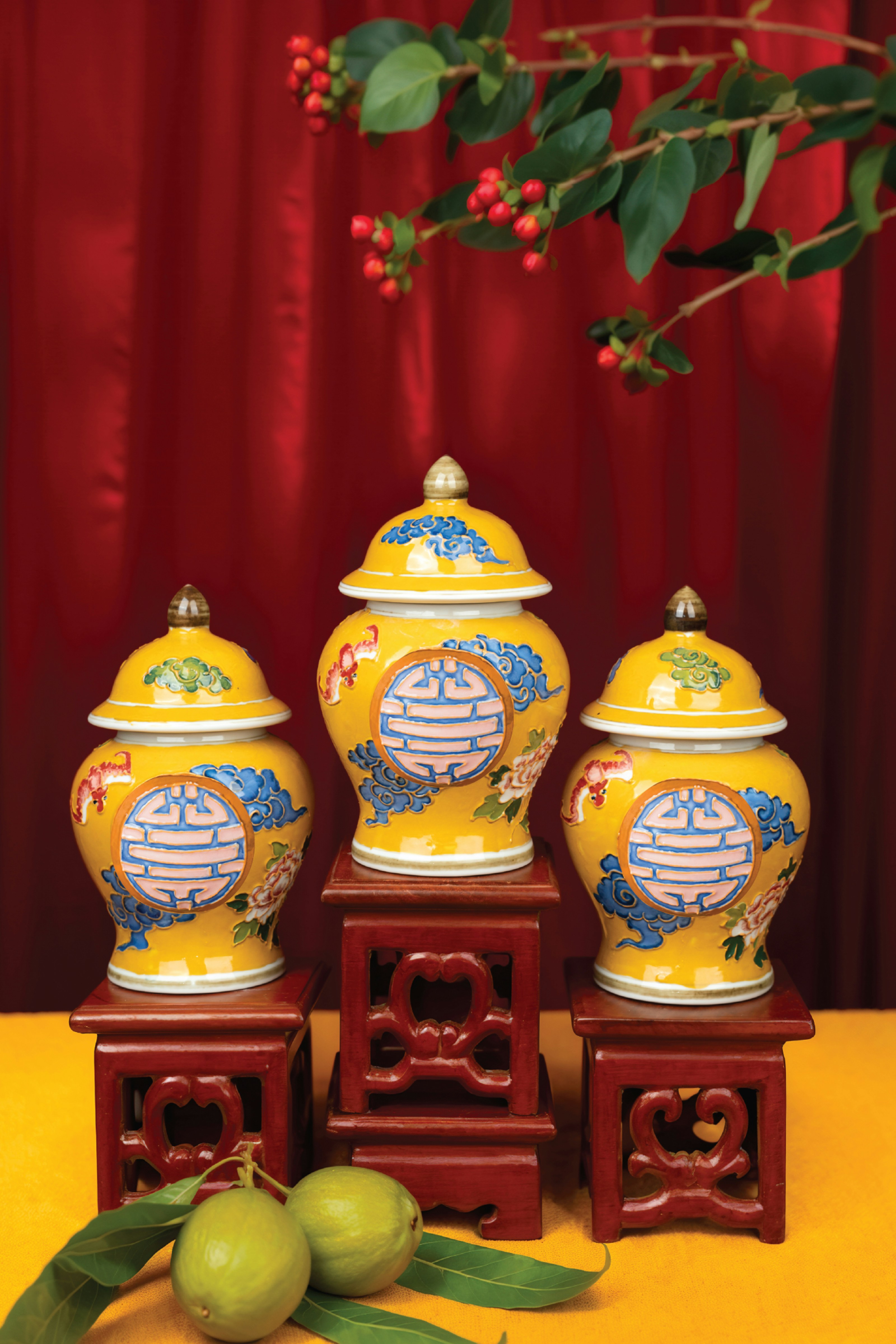 A group of three yellow vases sitting on top of a table