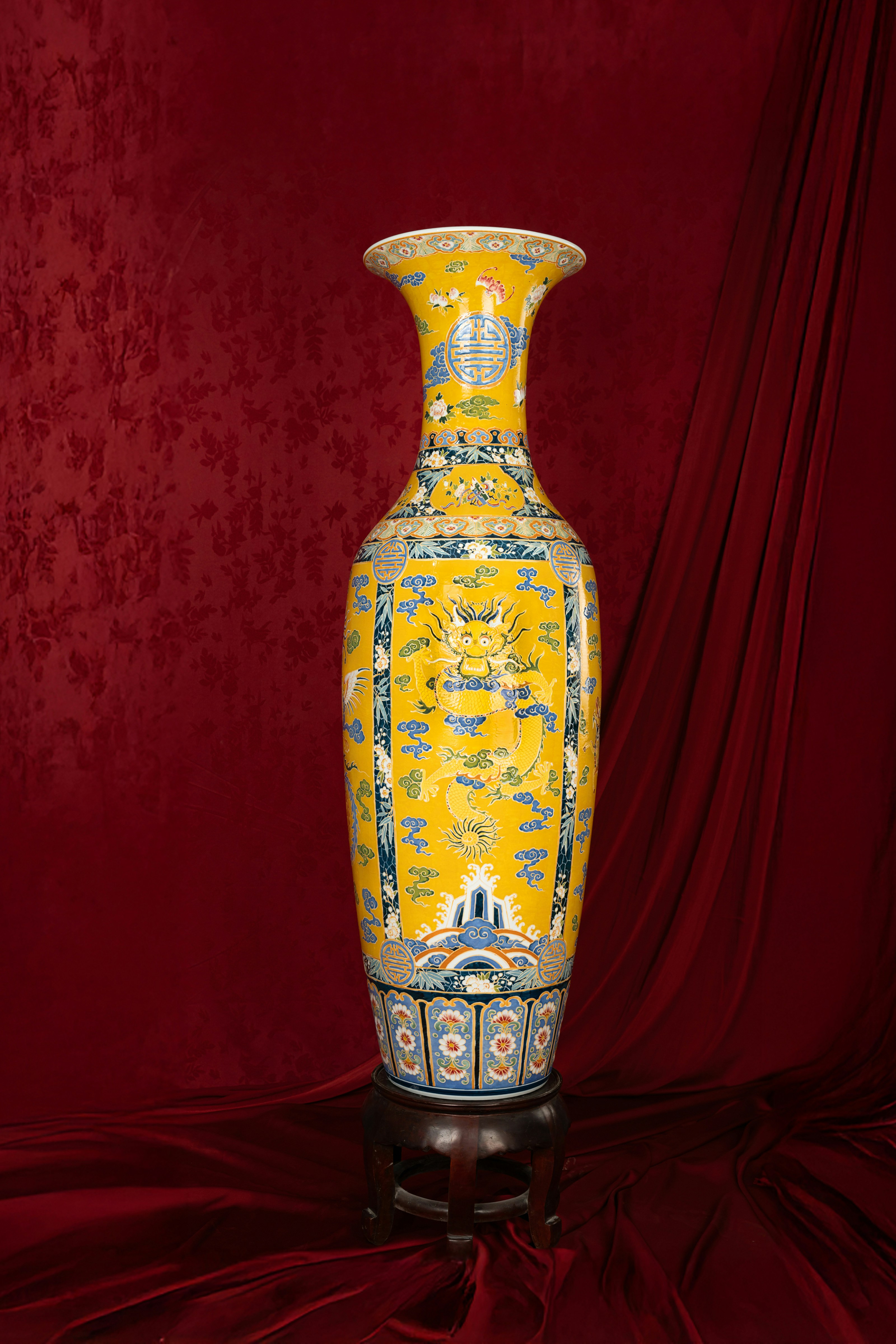 A yellow vase sitting on top of a table