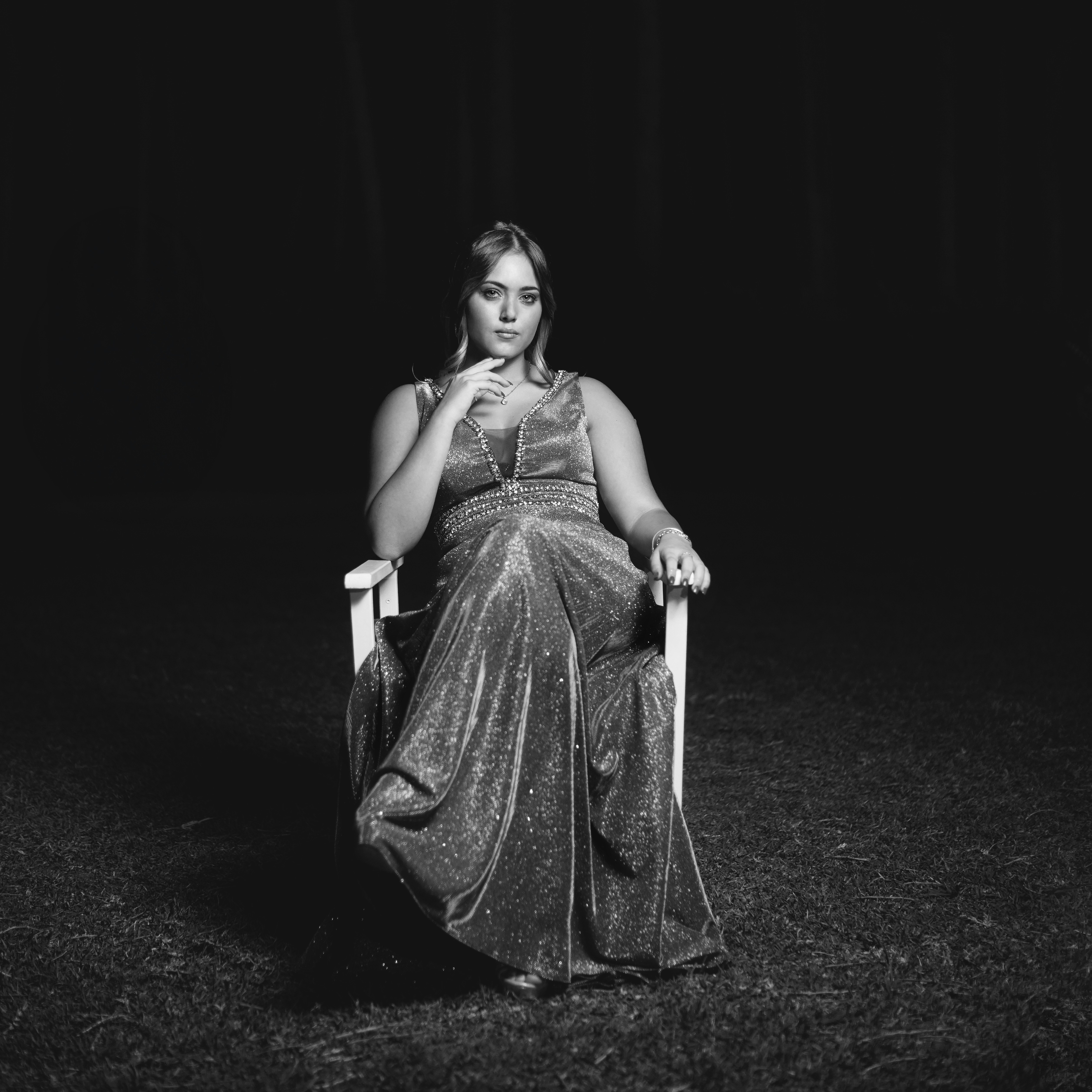 A woman sitting in a chair in the dark