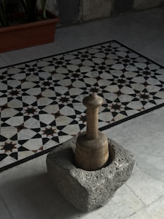 A black and white tile floor with a chess piece on it