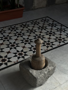 A black and white tile floor with a chess piece on it
