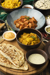 A wooden plate topped with lots of different types of food