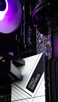 A close up of a computer tower with a purple light