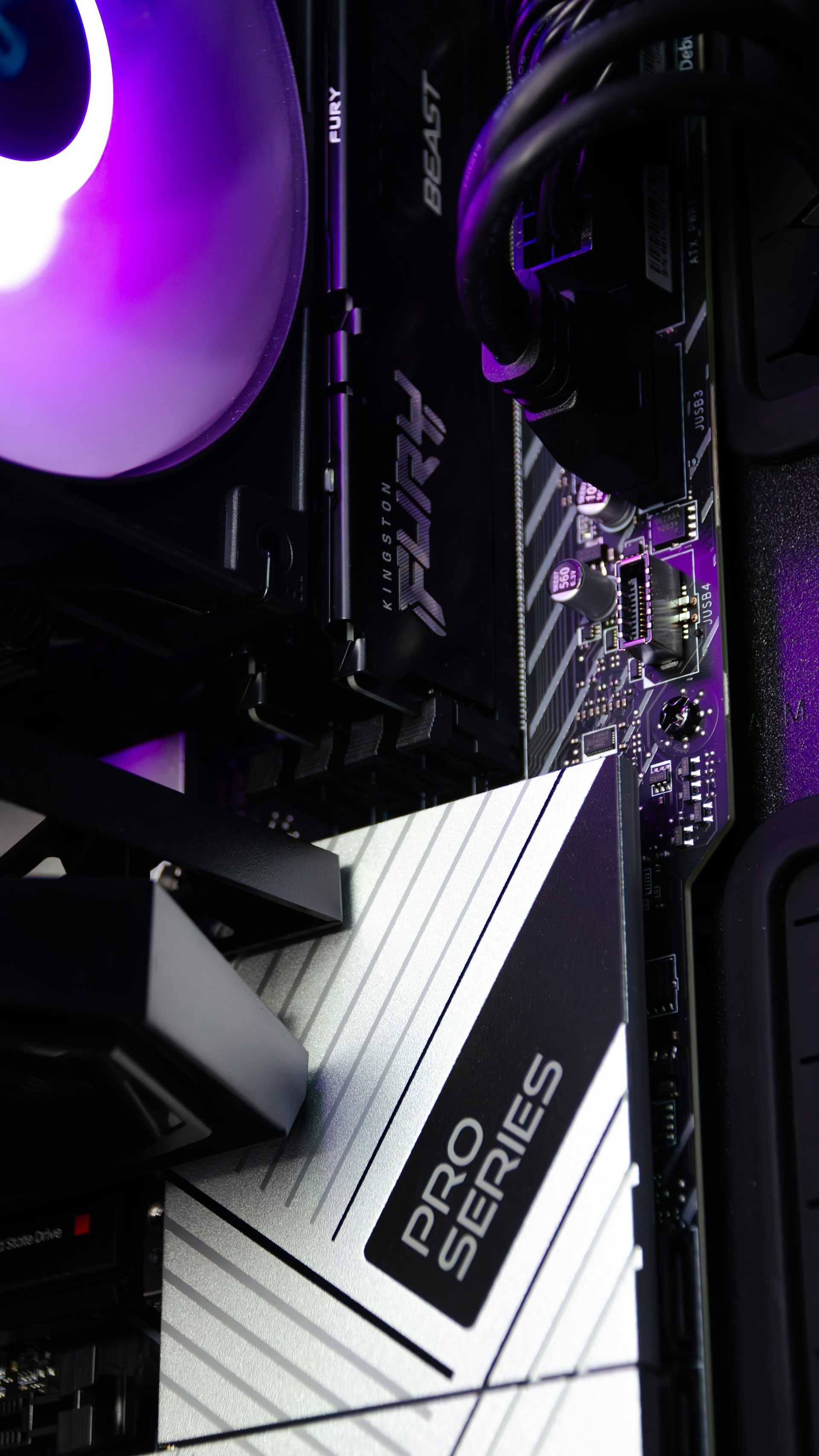 A close up of a computer tower with a purple light