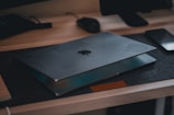 A desk with a laptop and a book on it