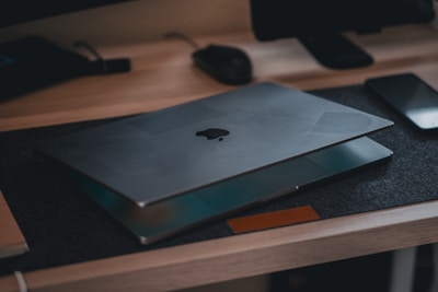 A desk with a laptop and a book on it