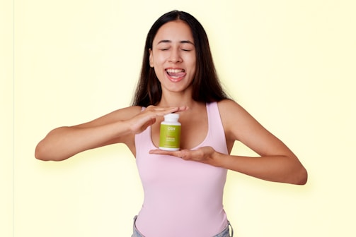 A woman holding a jar of green stuff
