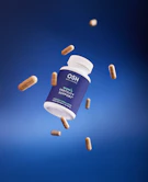 A bottle of hoo's vitamin supplement flying through the air