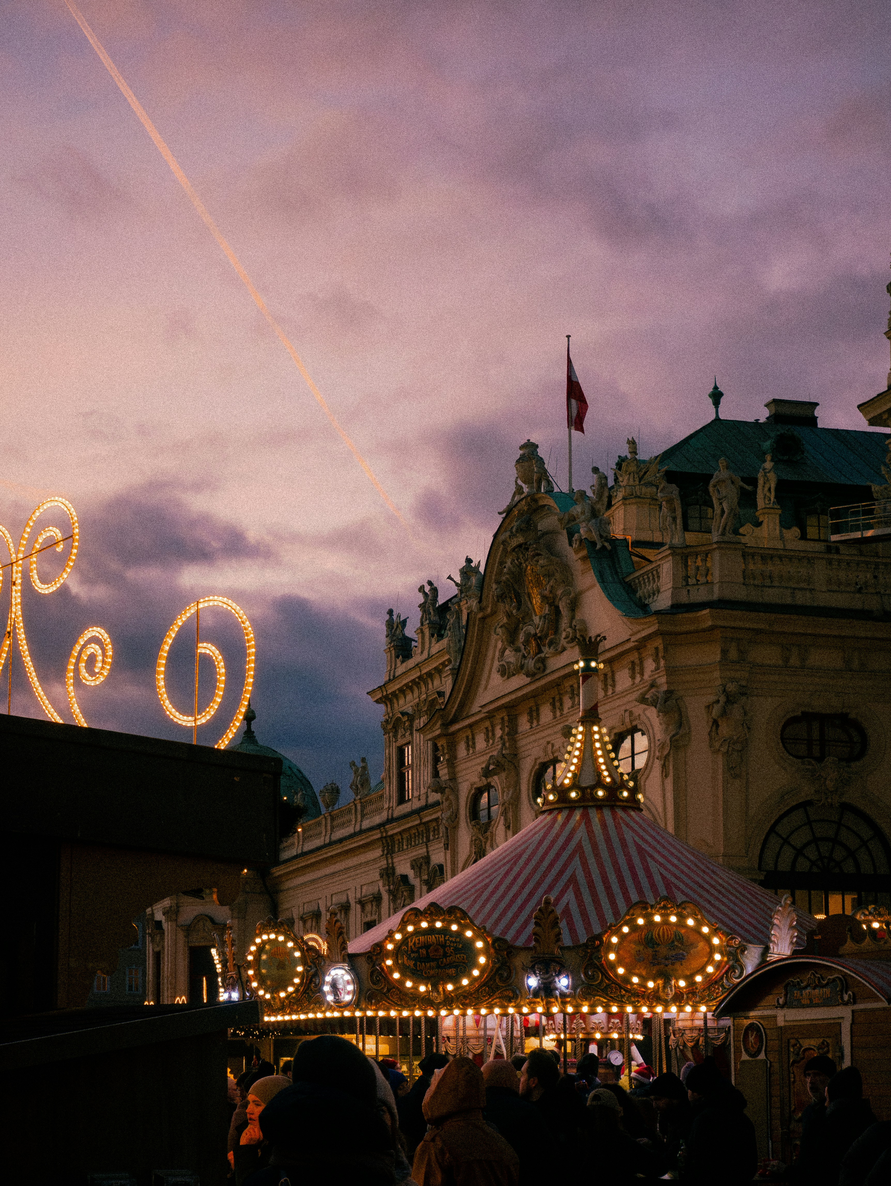 A crowd of people standing around a carnival