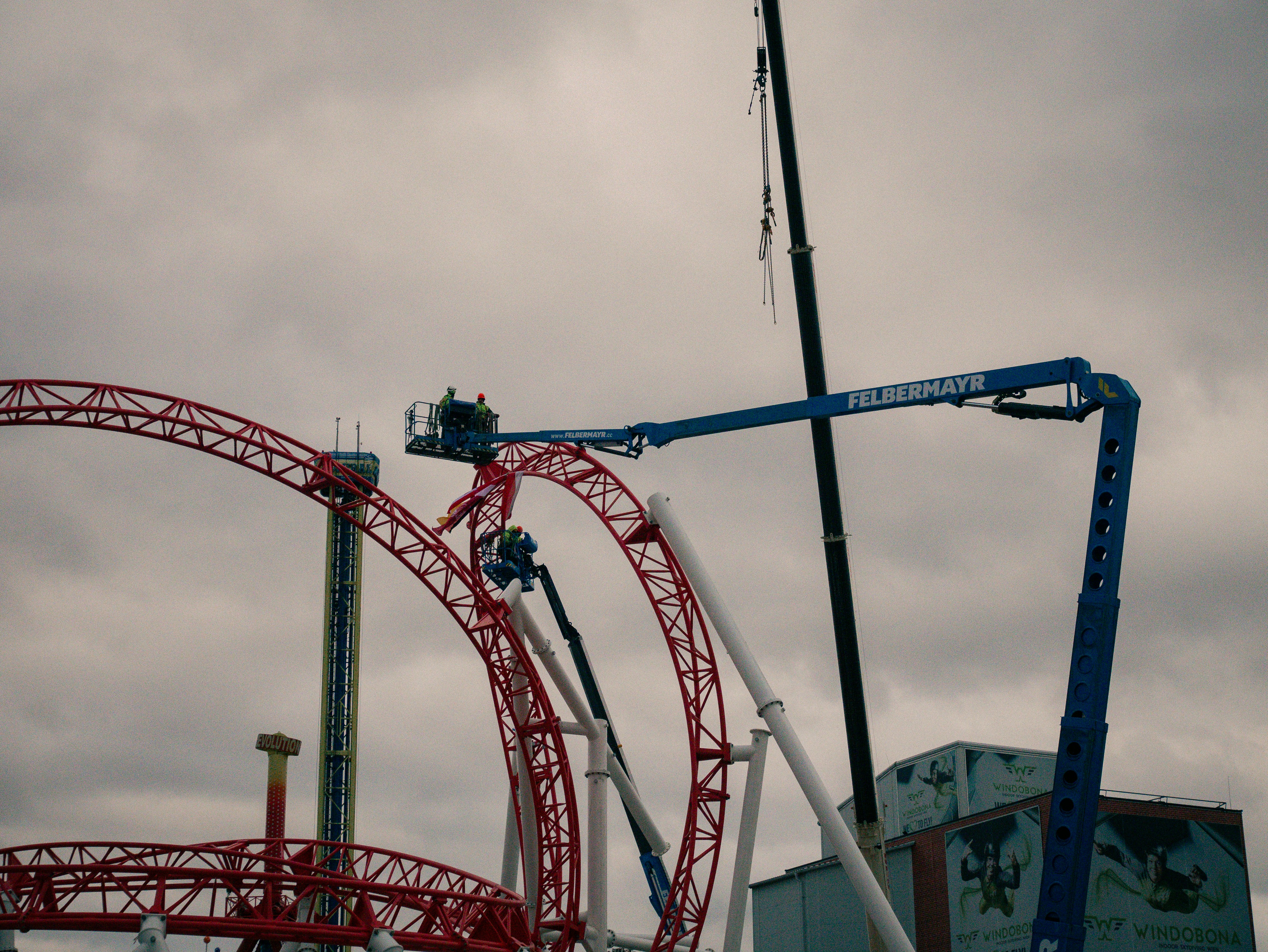 A roller coaster being lifted by a crane