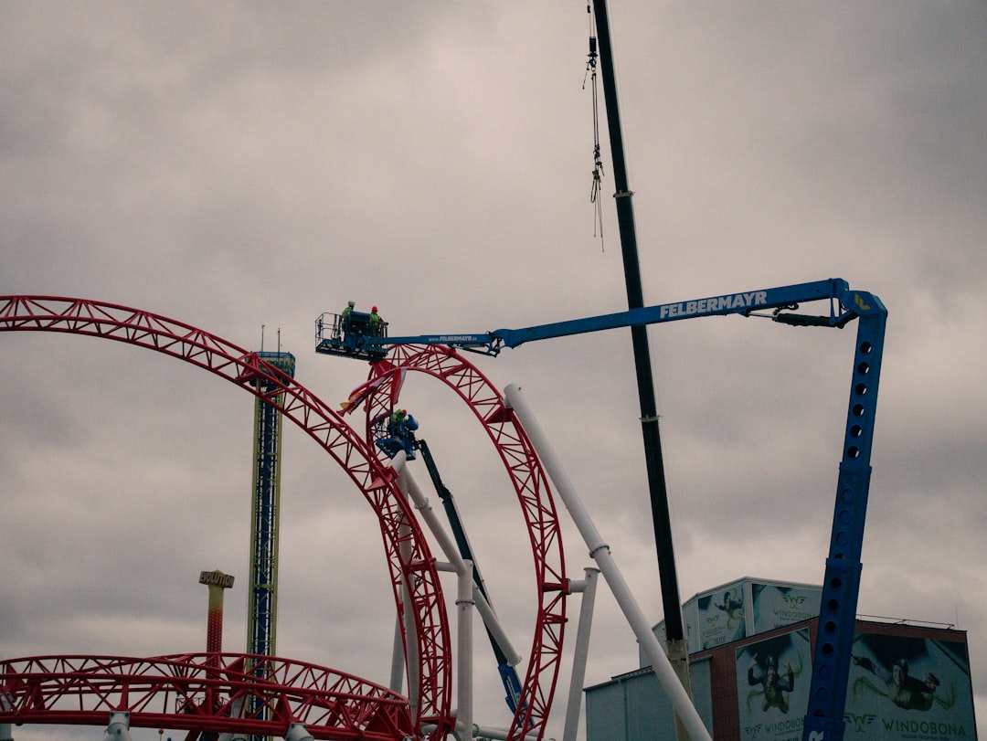 A roller coaster being lifted by a crane