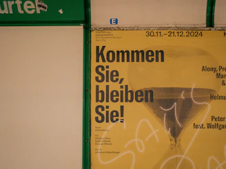 A poster on a wall with writing on it